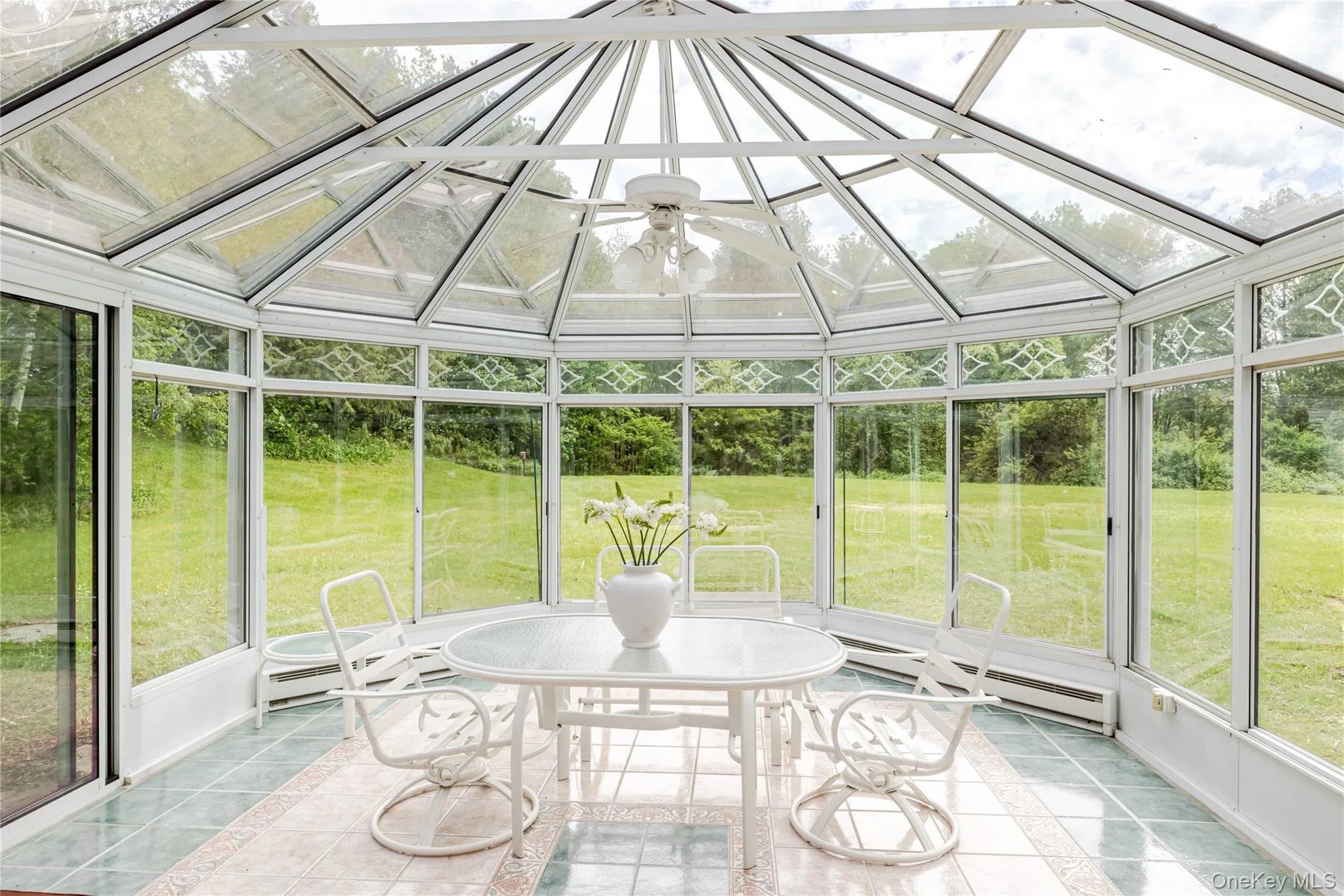 Sunroom / solarium with a baseboard radiator and vaulted ceiling Sunroom / solarium with a baseboard radiator and vaulted ceiling