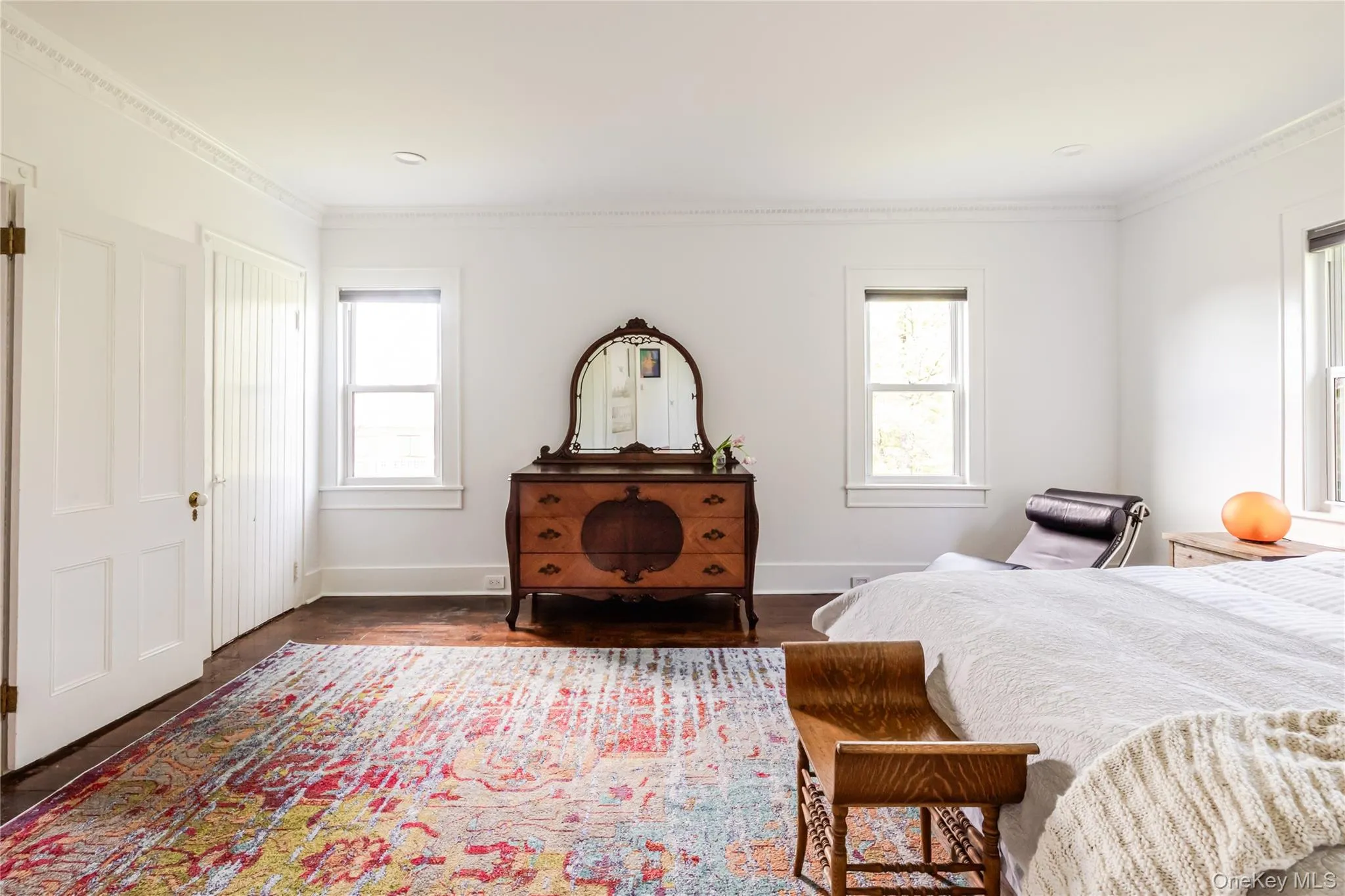 Bedroom featuring ornamental molding, baseboards, and dark wood finished floors Bedroom featuring ornamental molding, baseboards, and dark wood finished floors