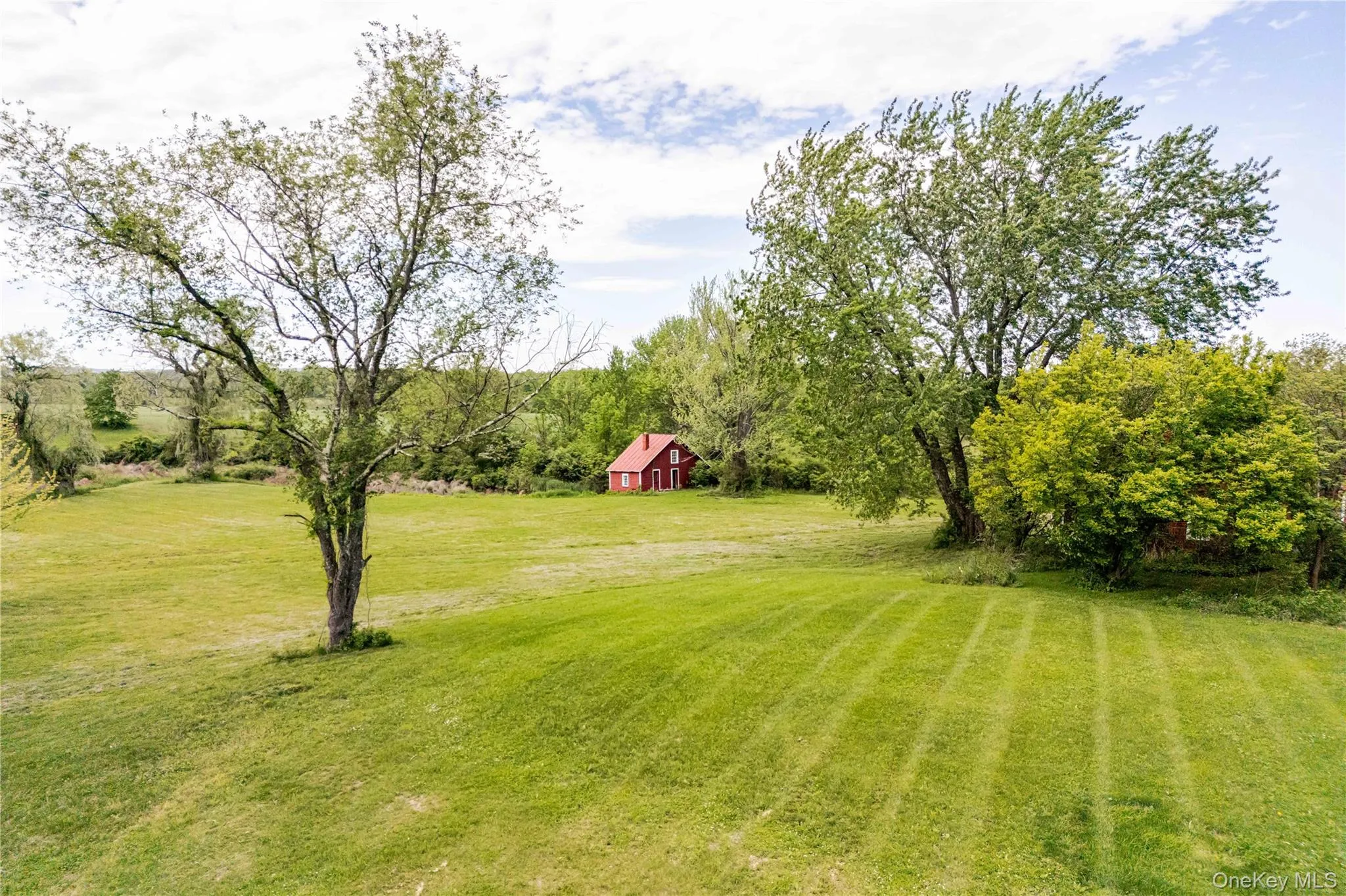 View of grassy yard with a barn and an outbuilding View of grassy yard with a barn and an outbuilding
