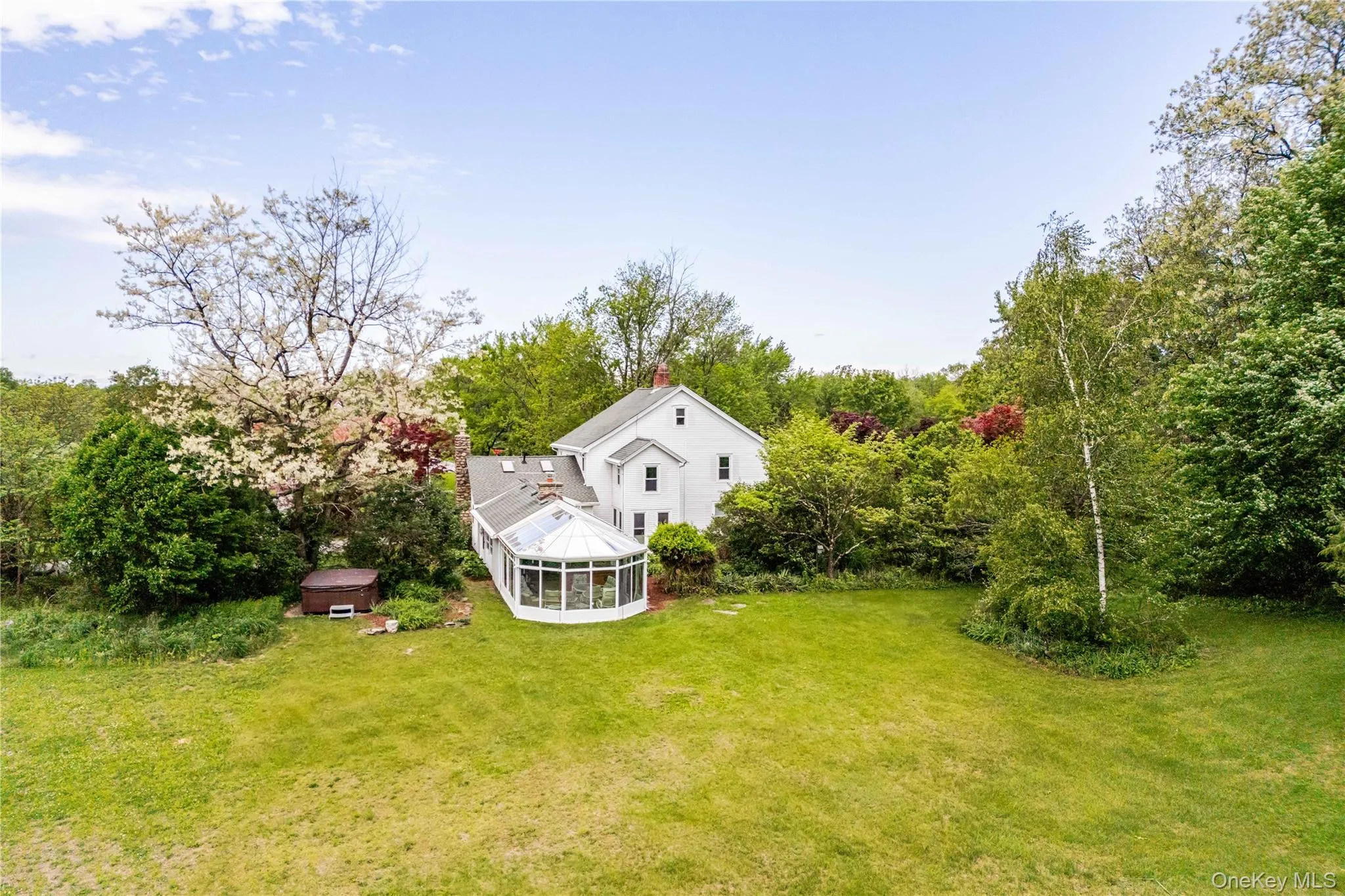 View of grassy yard with a sunroom View of grassy yard with a sunroom