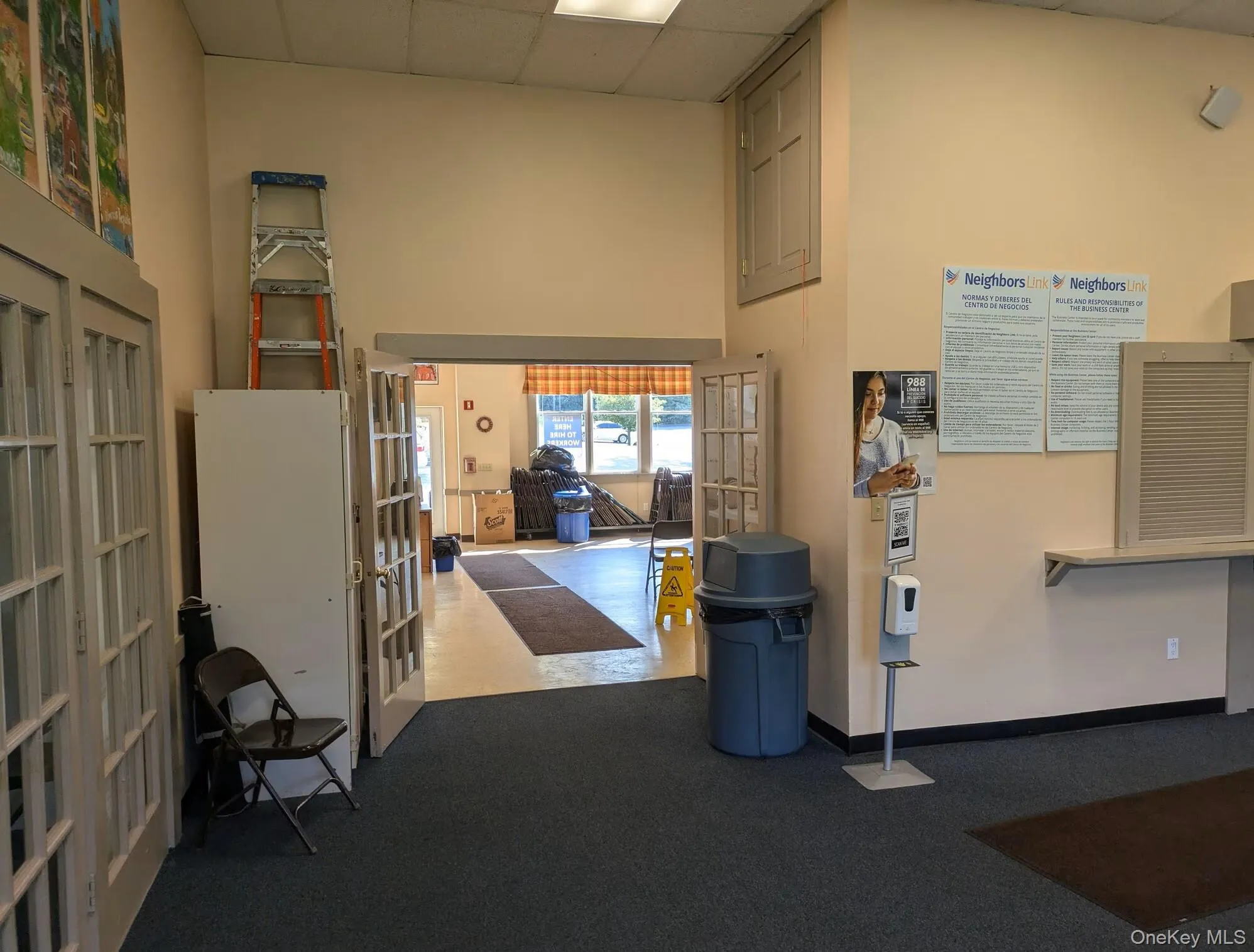 Miscellaneous room with french doors, a paneled ceiling, a high ceiling, and baseboards Miscellaneous room with french doors, a paneled ceiling, a high ceiling, and baseboards