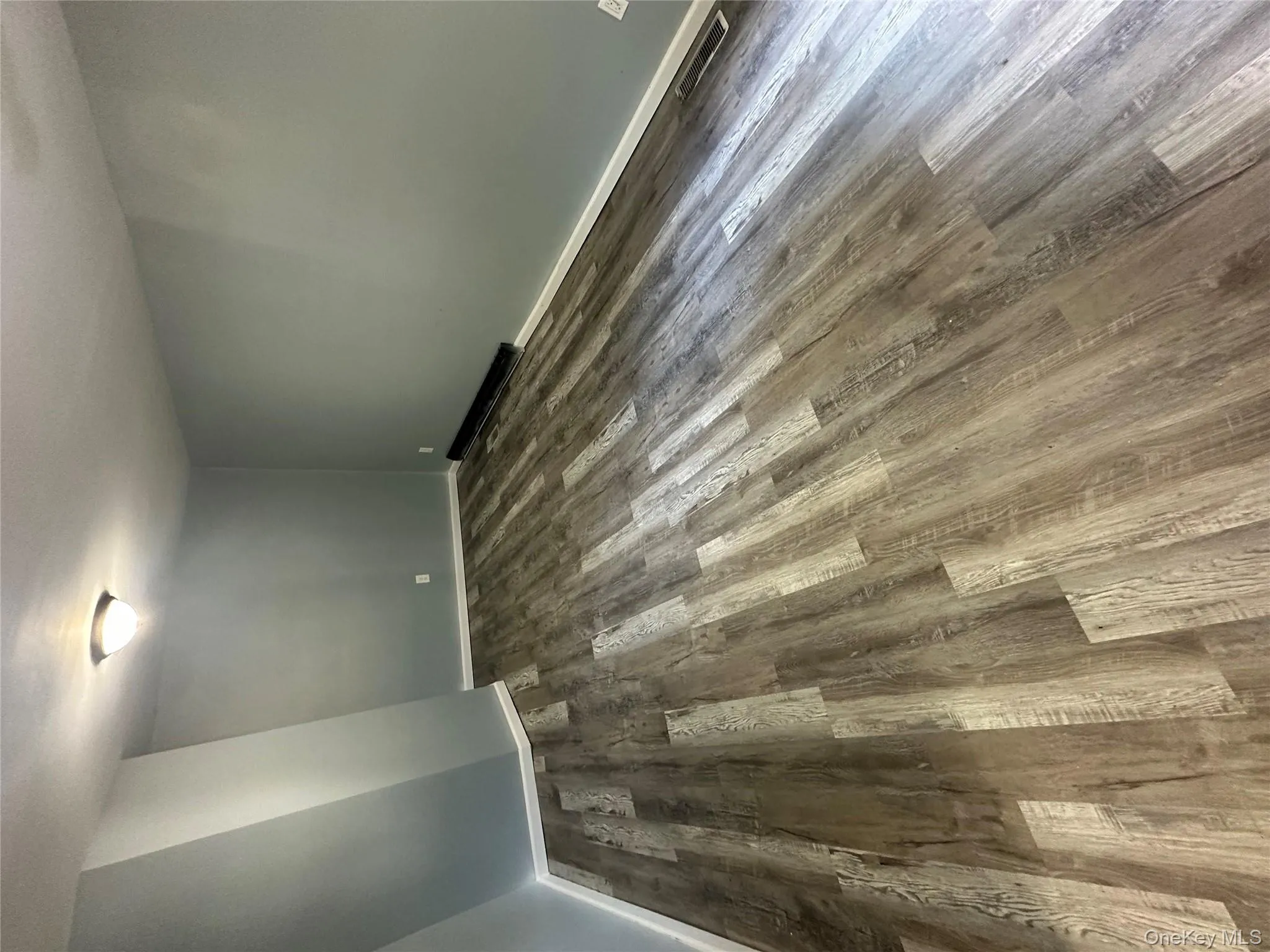 Below grade area featuring dark wood-type flooring and baseboards Below grade area featuring dark wood-type flooring and baseboards