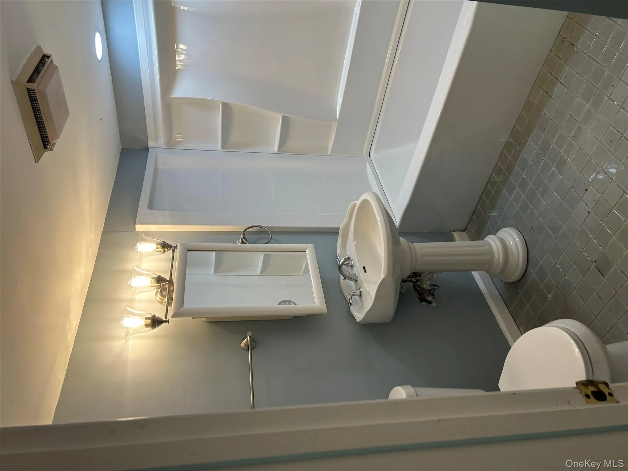 Bathroom featuring toilet, baseboards, and bathtub / shower combination Bathroom featuring toilet, baseboards, and bathtub / shower combination