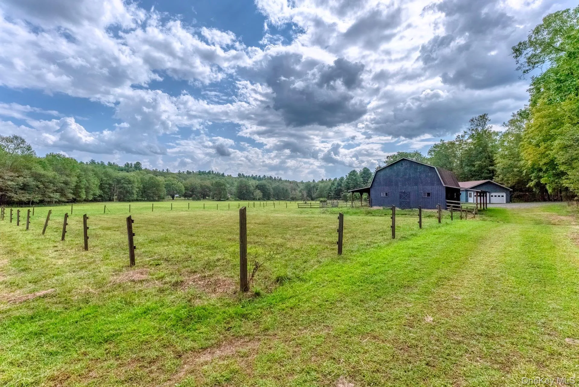 View of yard featuring a barn, a view of rural / pastoral area, an outdoor structure, and a wooded view View of yard featuring a barn, a view of rural / pastoral area, an outdoor structure, and a wooded view