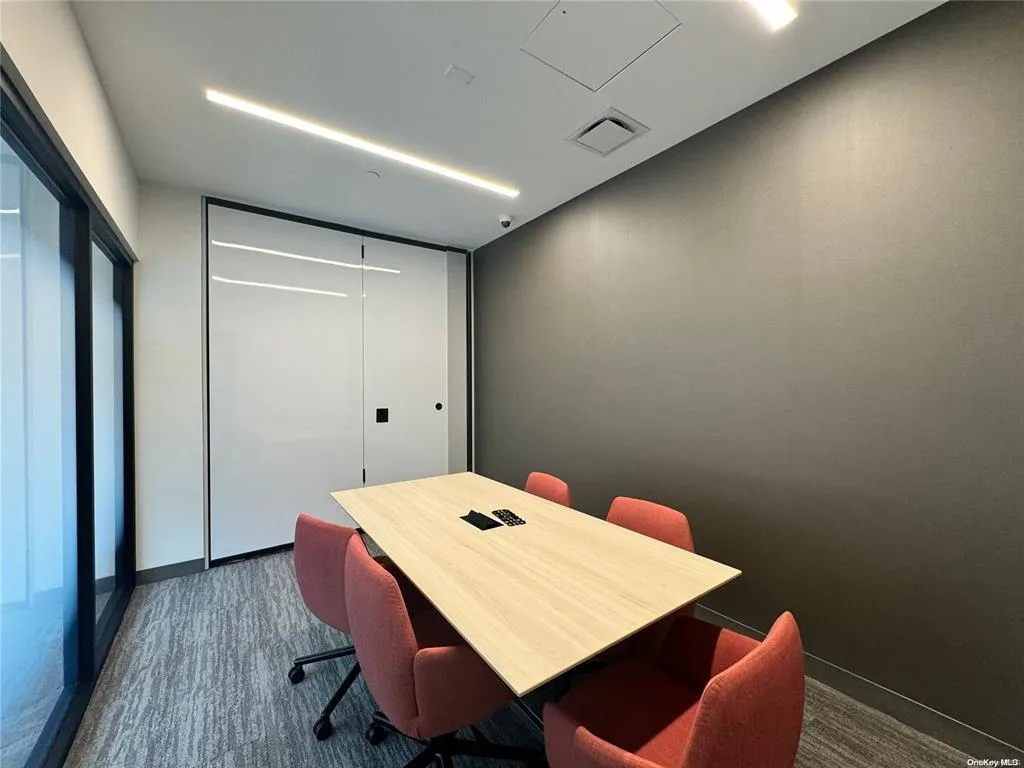 Office area featuring dark carpet and baseboards Office area featuring dark carpet and baseboards