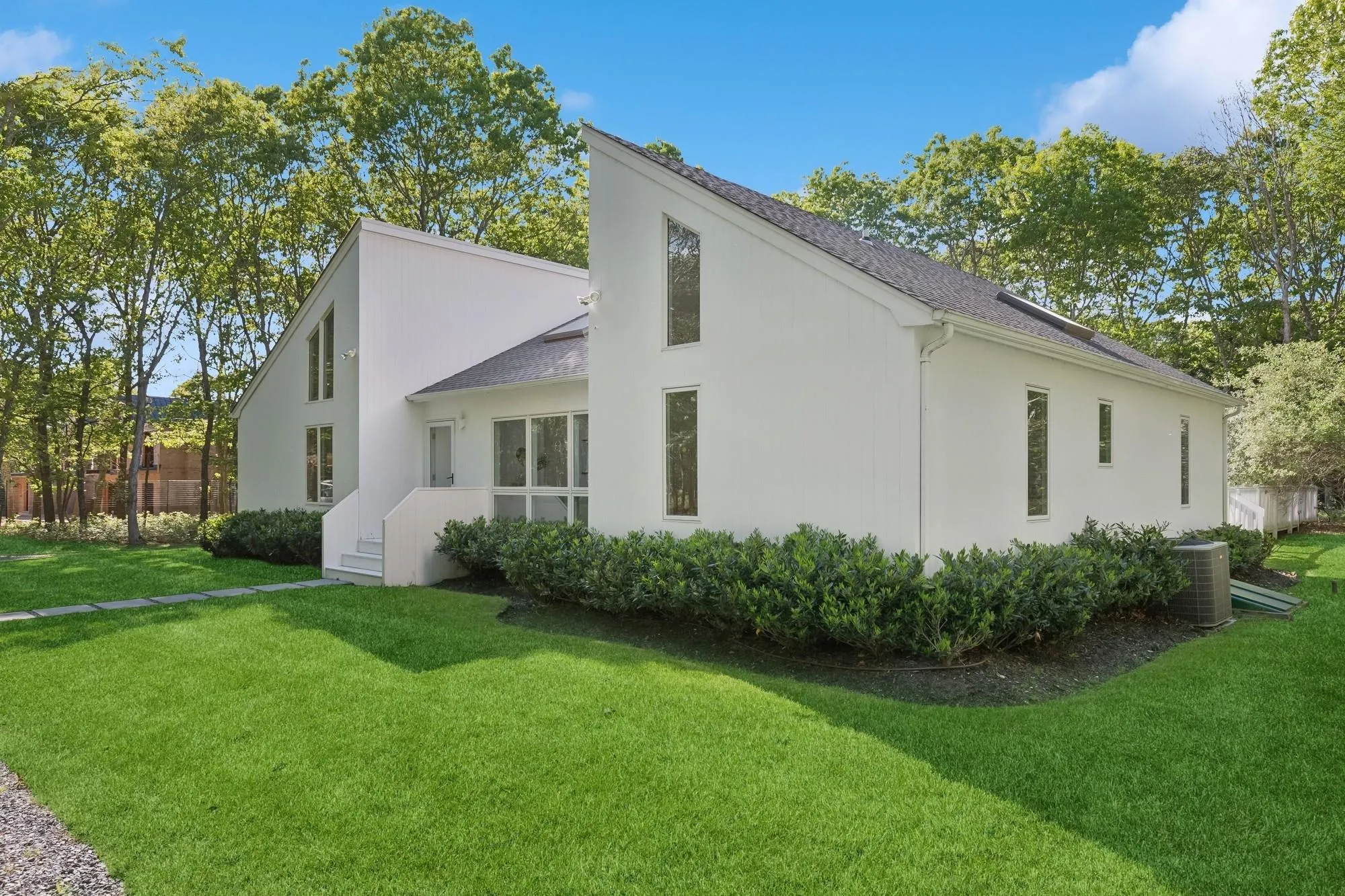 View of home's exterior with roof with shingles, a yard, central air condition unit, and stucco siding View of home's exterior with roof with shingles, a yard, central air condition unit, and stucco siding