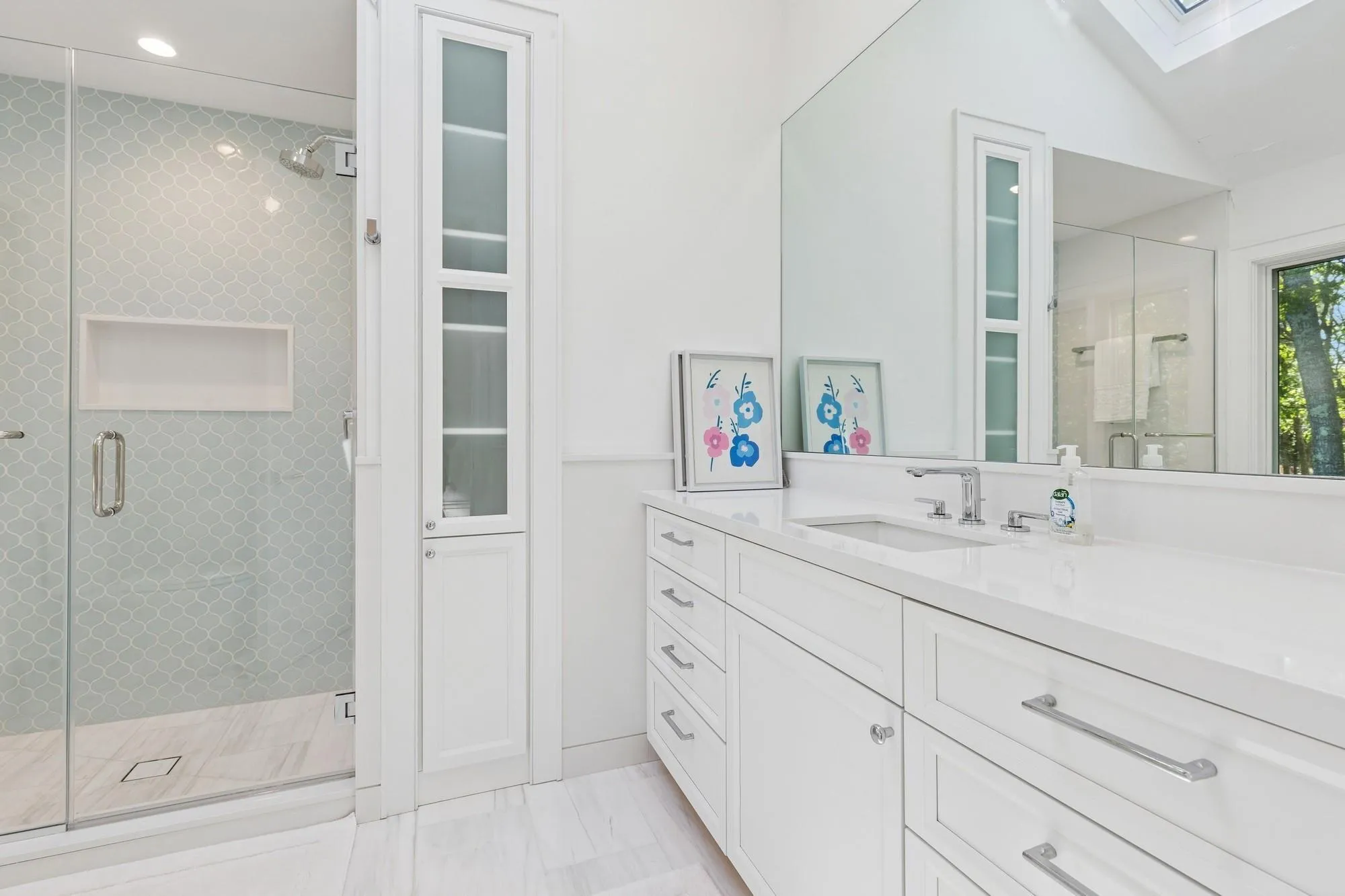 Full bath featuring a skylight, vanity, a stall shower, marble look tile flooring, and recessed lighting Full bath featuring a skylight, vanity, a stall shower, marble look tile flooring, and recessed lighting