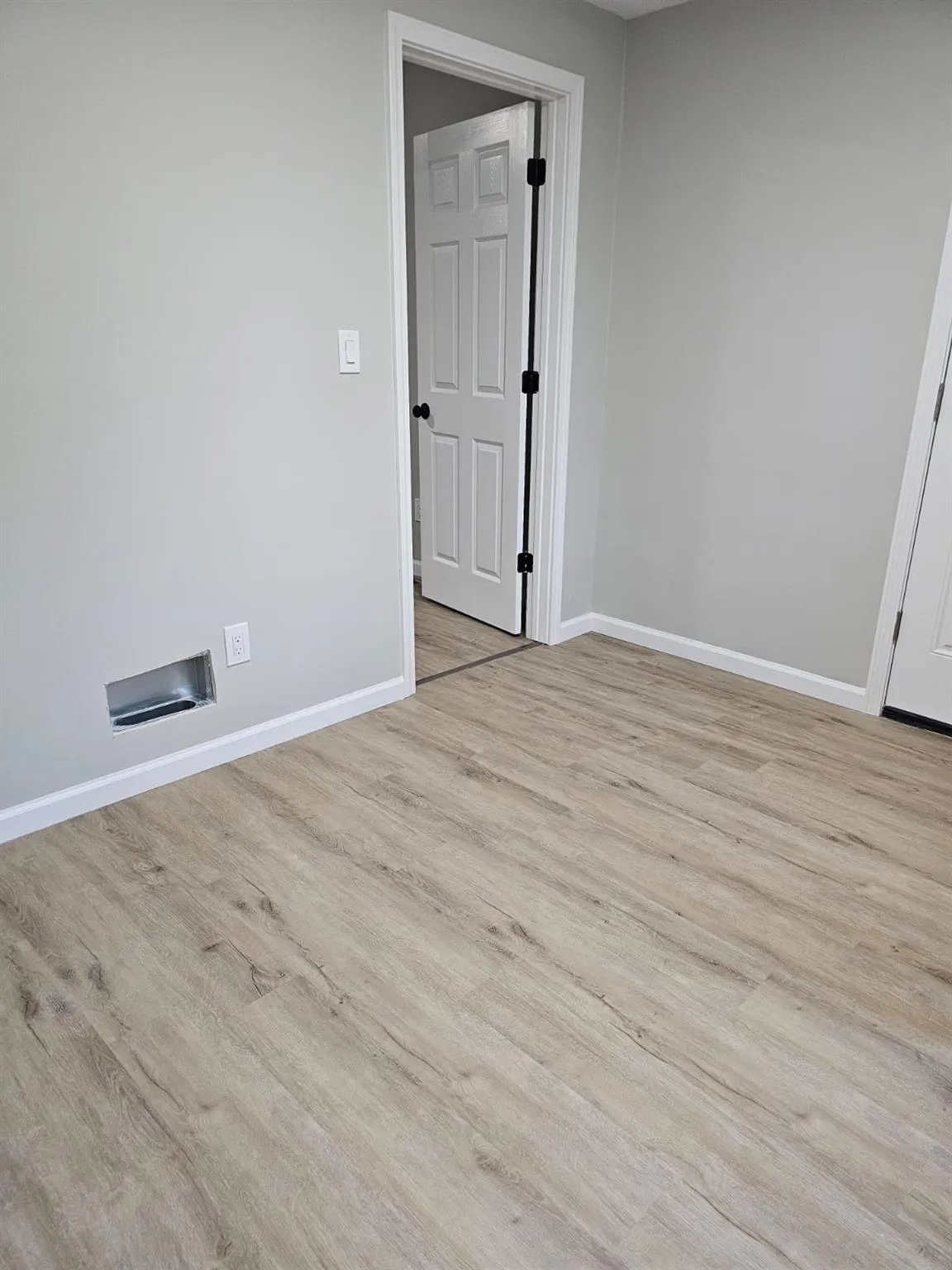 Empty room featuring wood finished floors and baseboards Empty room featuring wood finished floors and baseboards