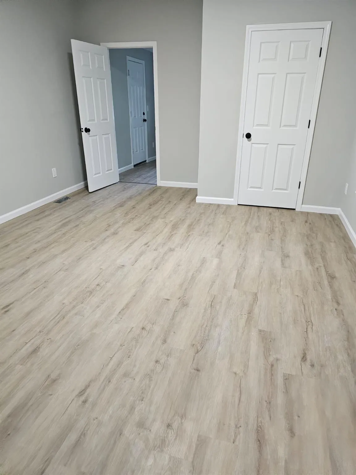 Unfurnished bedroom with baseboards and wood finished floors Unfurnished bedroom with baseboards and wood finished floors