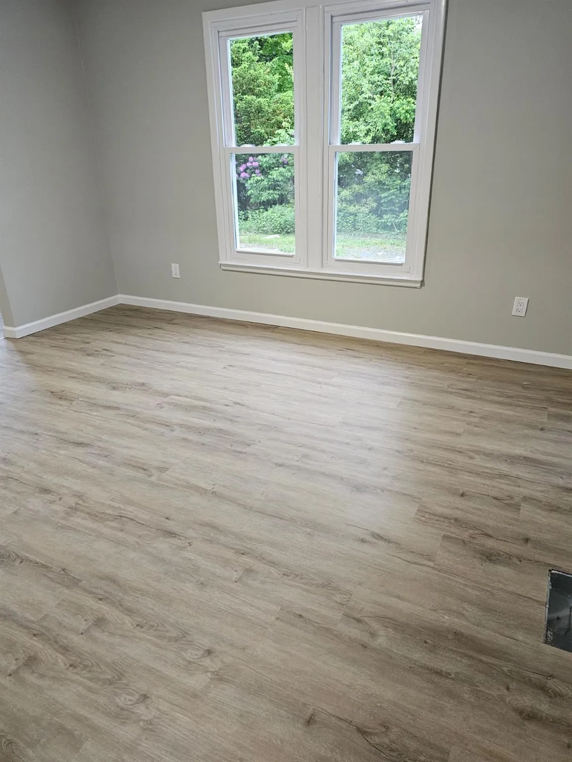 Spare room featuring baseboards and wood finished floors Spare room featuring baseboards and wood finished floors