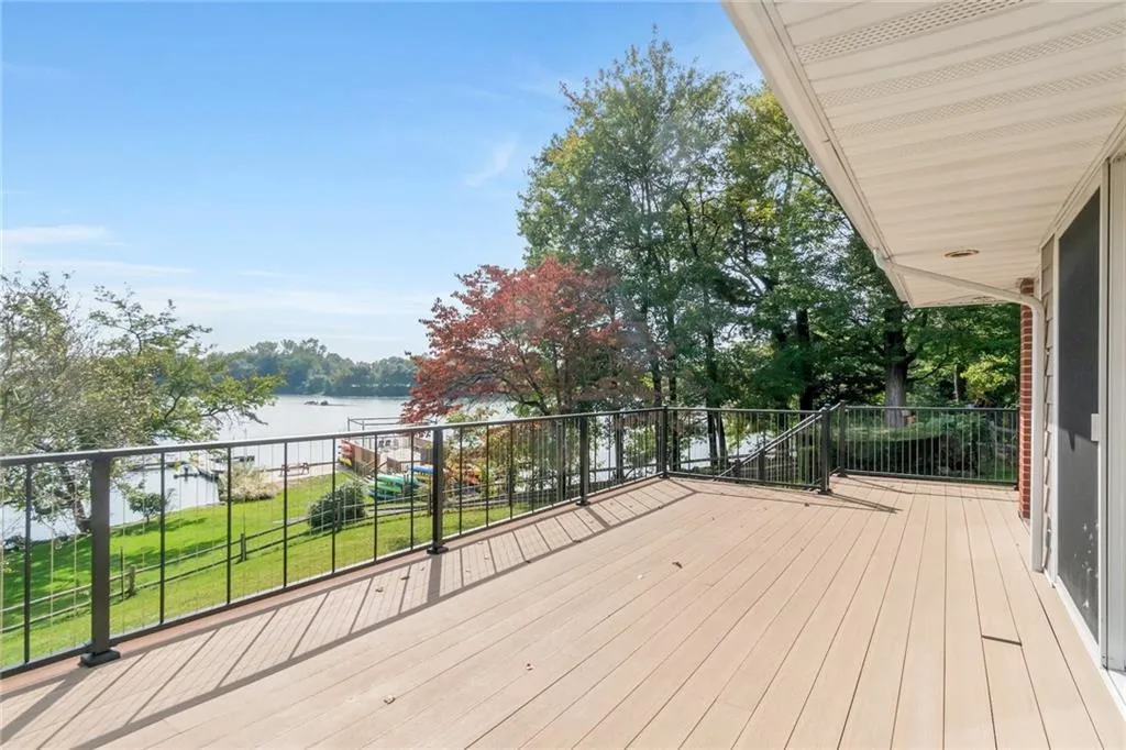 Deck with a water view and a lawn Deck with a water view and a lawn