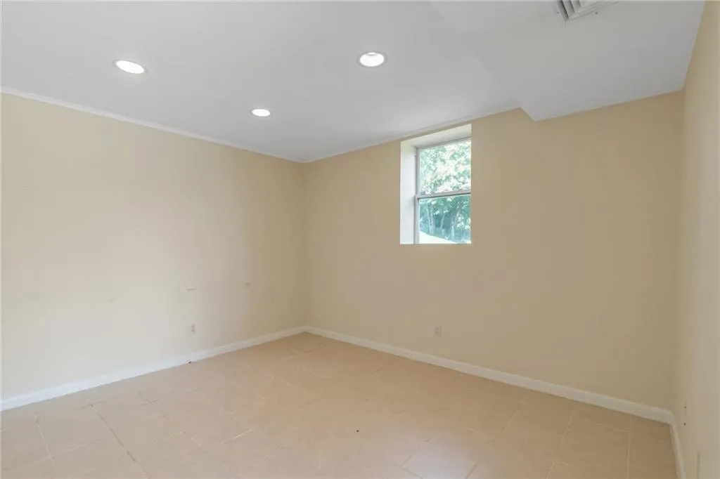 Unfurnished room with recessed lighting, baseboards, and light tile patterned floors Unfurnished room with recessed lighting, baseboards, and light tile patterned floors