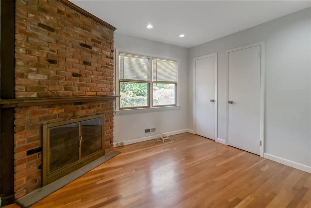 Unfurnished living room featuring baseboards, light wood finished floors, a fireplace, and recessed lighting Unfurnished living room featuring baseboards, light wood finished floors, a fireplace, and recessed lighting