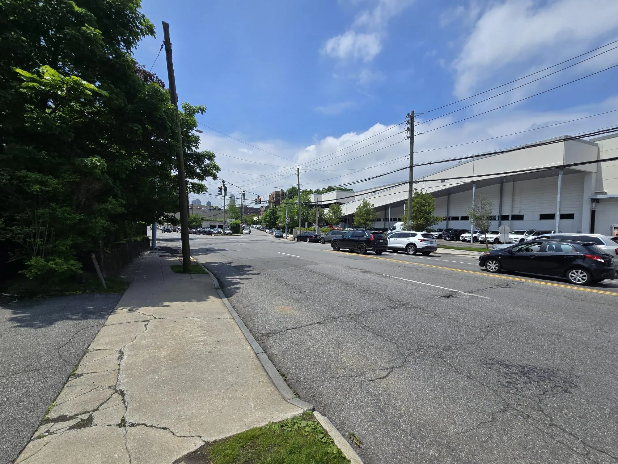 View of asphalt street featuring curbs and sidewalks View of asphalt street featuring curbs and sidewalks