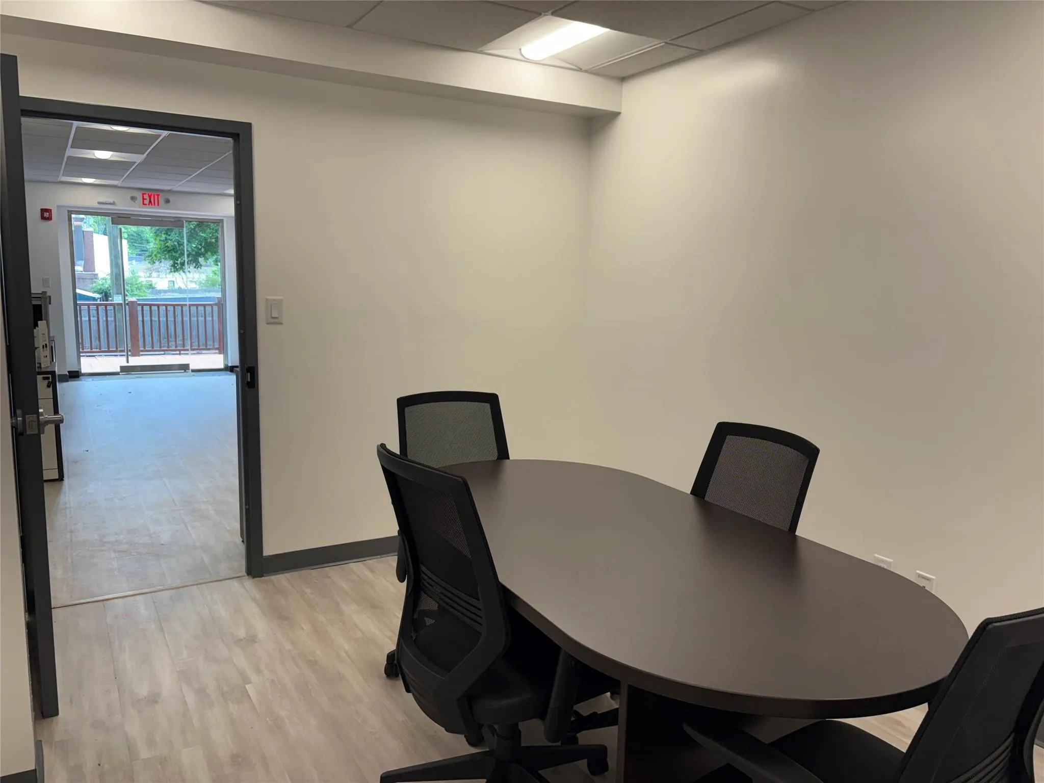 Office with a drop ceiling, light wood-style flooring, and baseboards Office with a drop ceiling, light wood-style flooring, and baseboards