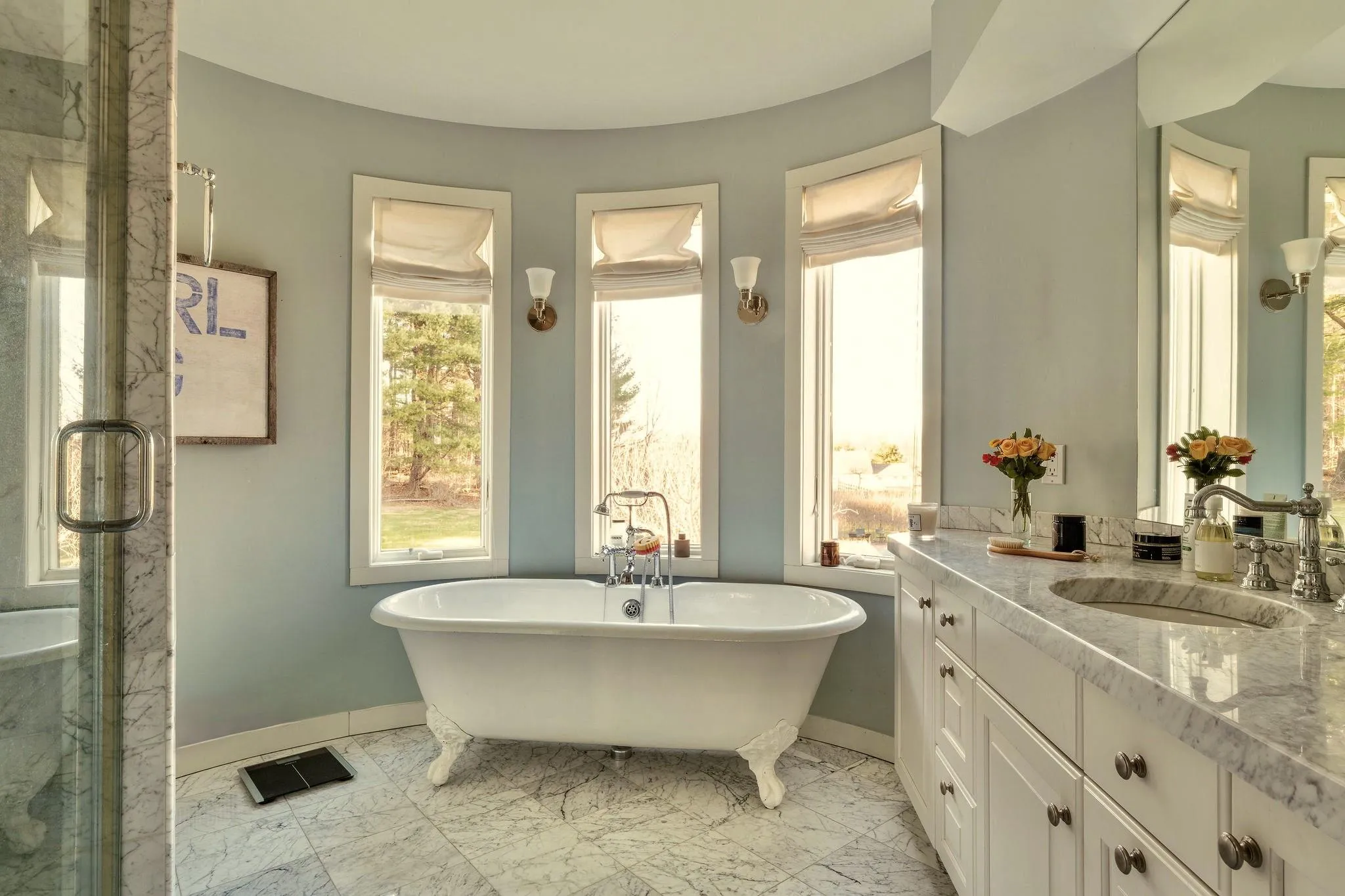 Bathroom with vanity, baseboards, marble finish floors, a freestanding tub, and a marble finish shower Bathroom with vanity, baseboards, marble finish floors, a freestanding tub, and a marble finish shower