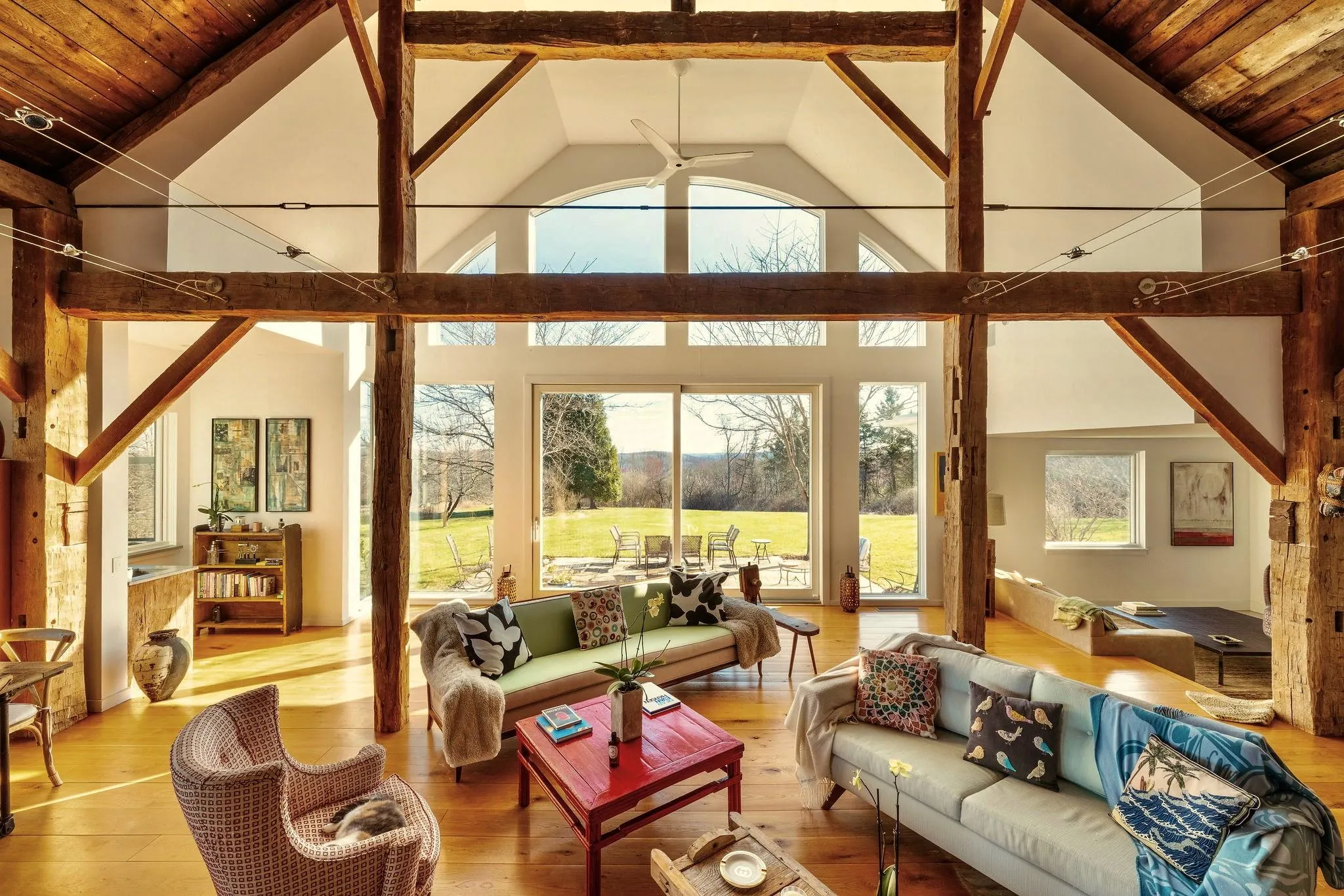 Living area featuring high vaulted ceiling, wooden ceiling, wood finished floors, and ceiling fan Living area featuring high vaulted ceiling, wooden ceiling, wood finished floors, and ceiling fan