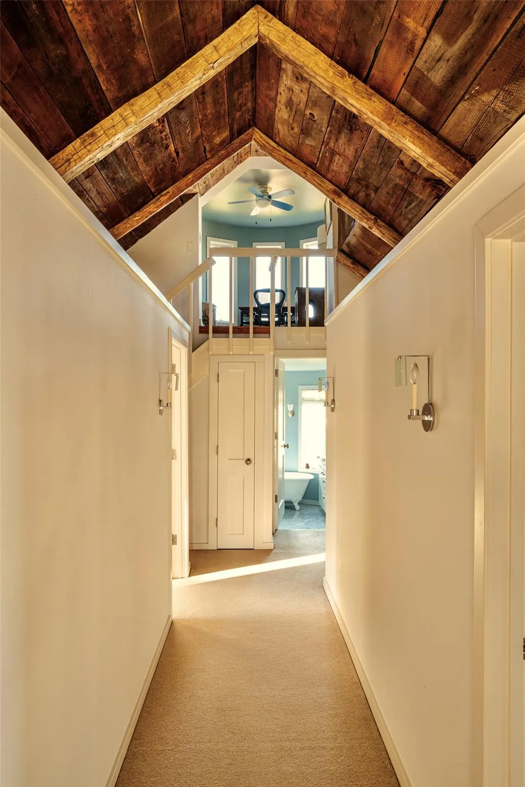 Hallway featuring wood ceiling, carpet flooring, lofted ceiling, and baseboards Hallway featuring wood ceiling, carpet flooring, lofted ceiling, and baseboards