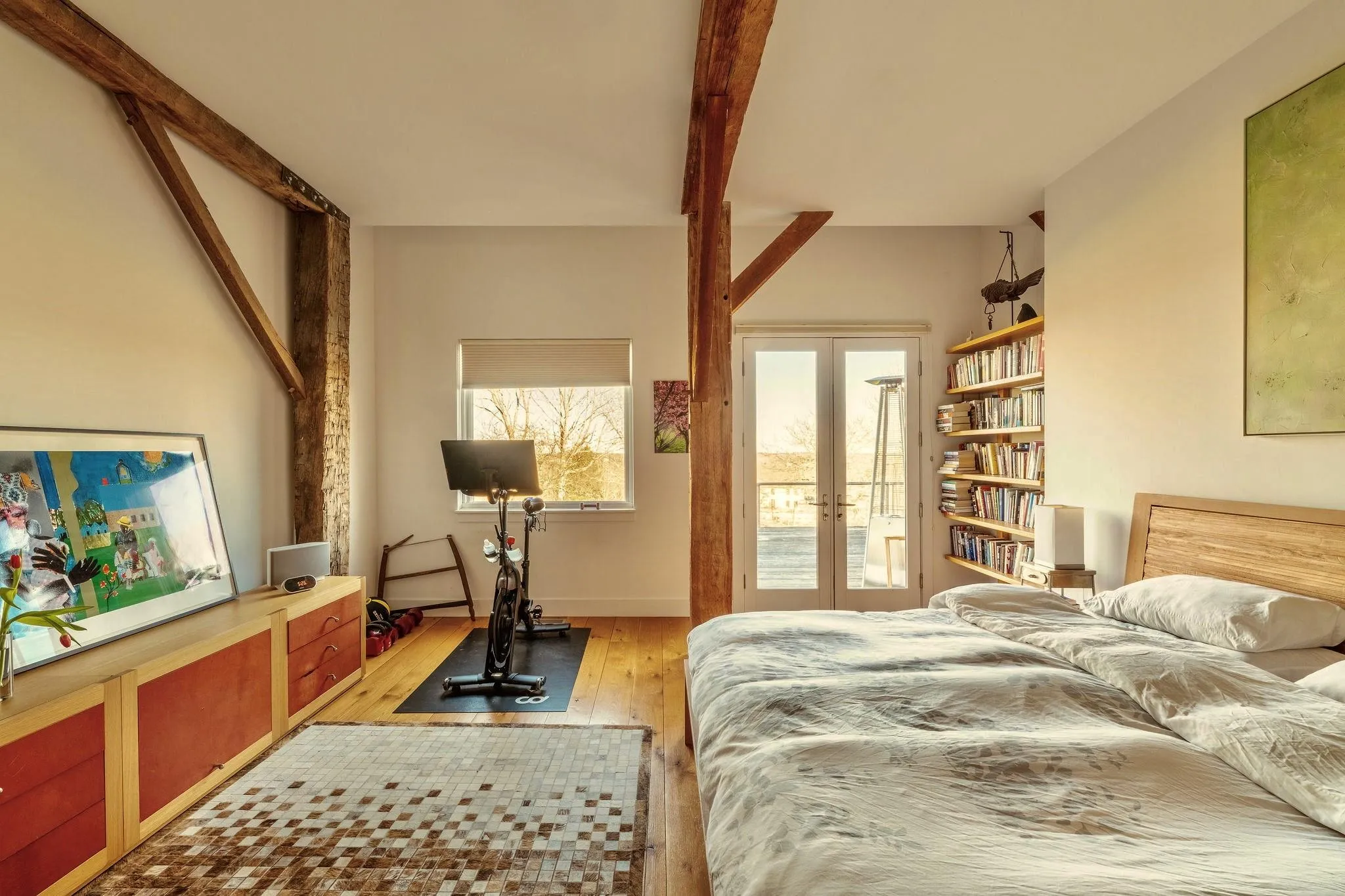 Bedroom featuring light wood-style flooring and french doors Bedroom featuring light wood-style flooring and french doors
