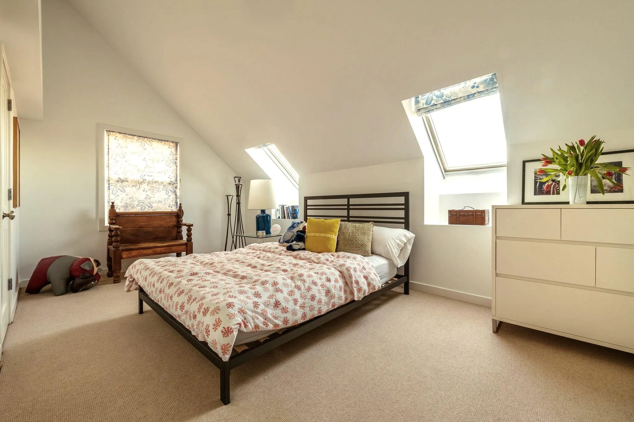 Bedroom with light carpet, vaulted ceiling, and baseboards Bedroom with light carpet, vaulted ceiling, and baseboards
