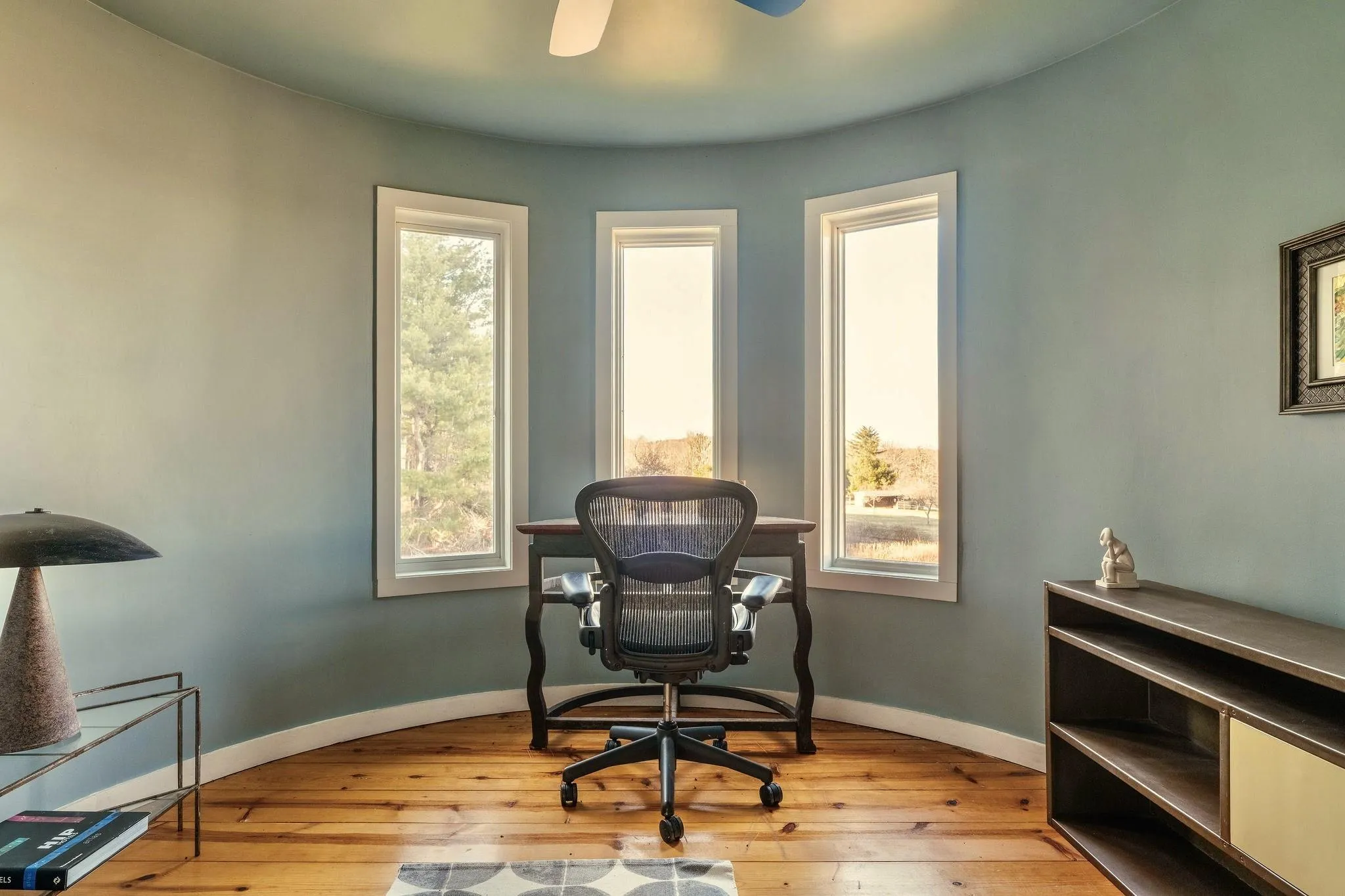 Office featuring light wood finished floors, baseboards, and a ceiling fan Office featuring light wood finished floors, baseboards, and a ceiling fan
