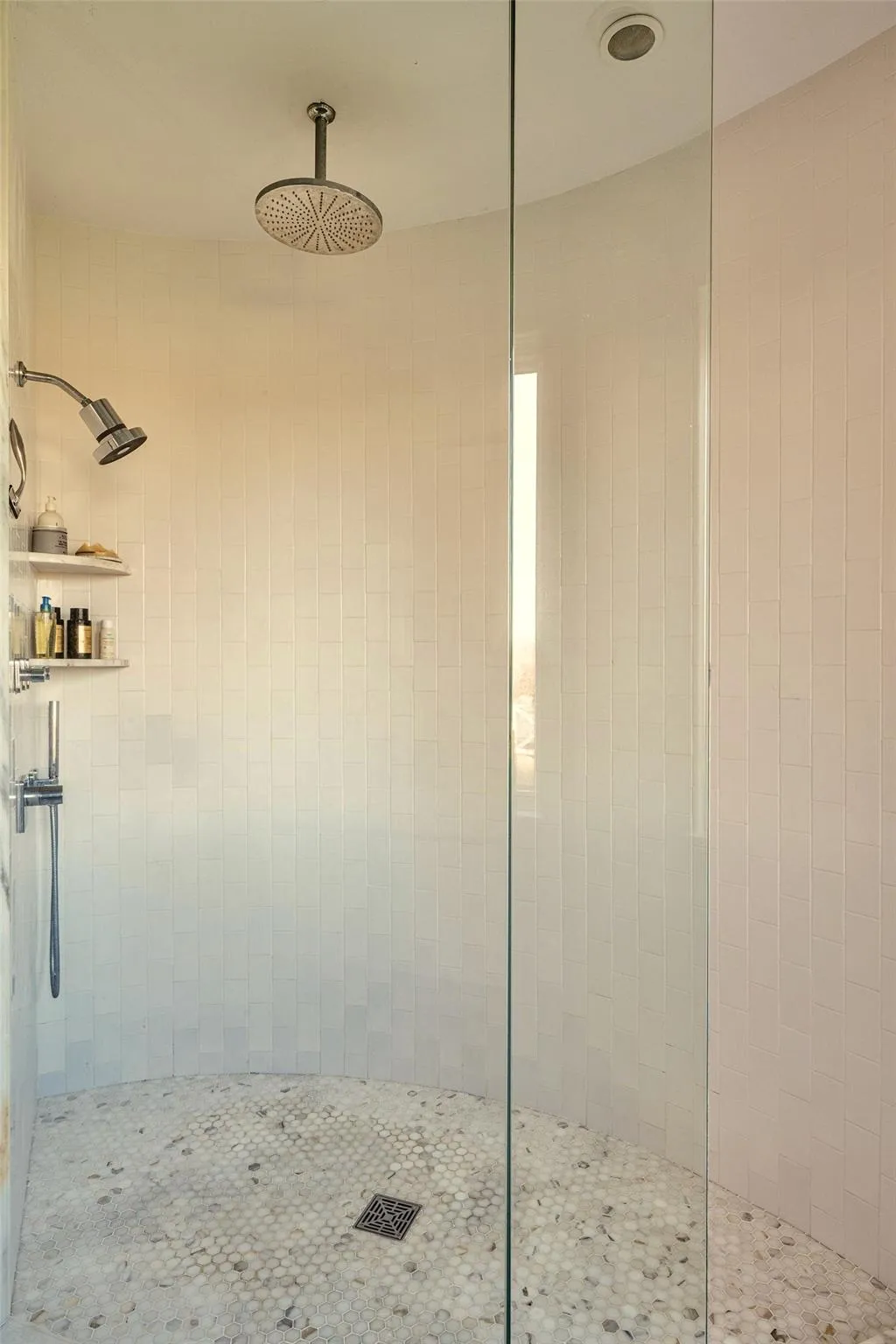 Full bathroom featuring a tile shower Full bathroom featuring a tile shower