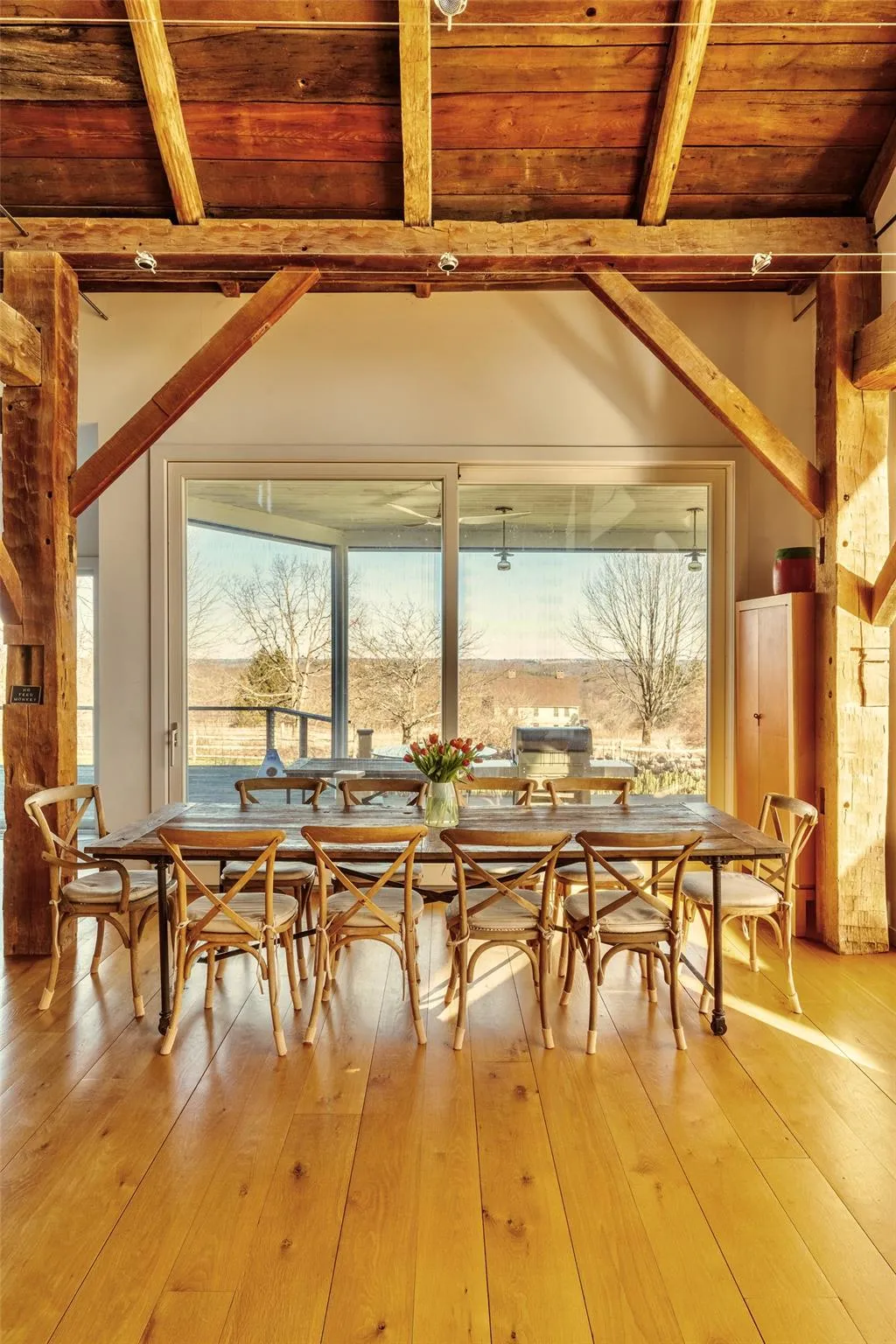 Dining space featuring wooden ceiling with exposed beams and light wood-style floors Dining space featuring wooden ceiling with exposed beams and light wood-style floors