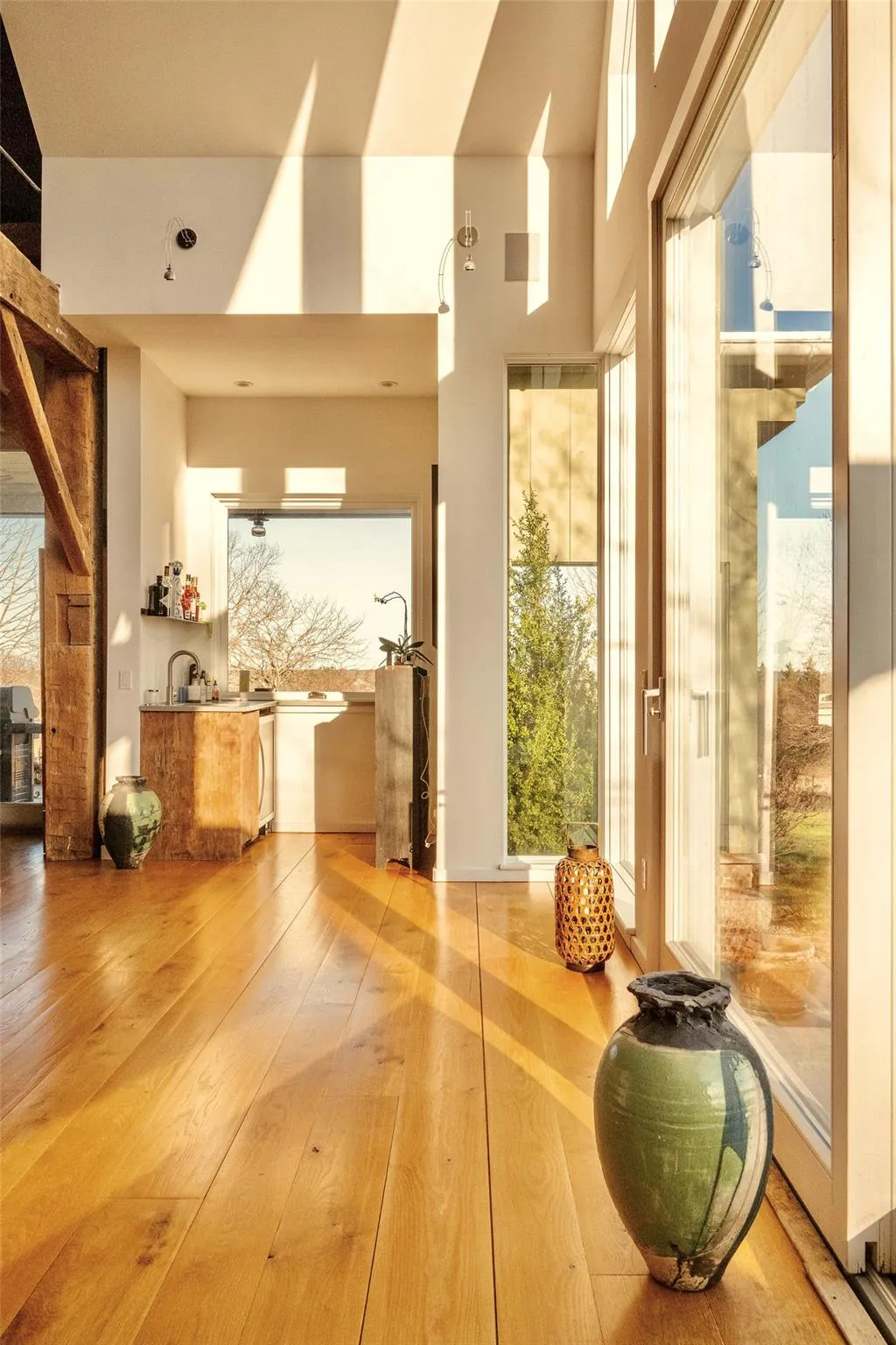 Exercise room with hardwood / wood-style floors, plenty of natural light, and a towering ceiling Exercise room with hardwood / wood-style floors, plenty of natural light, and a towering ceiling