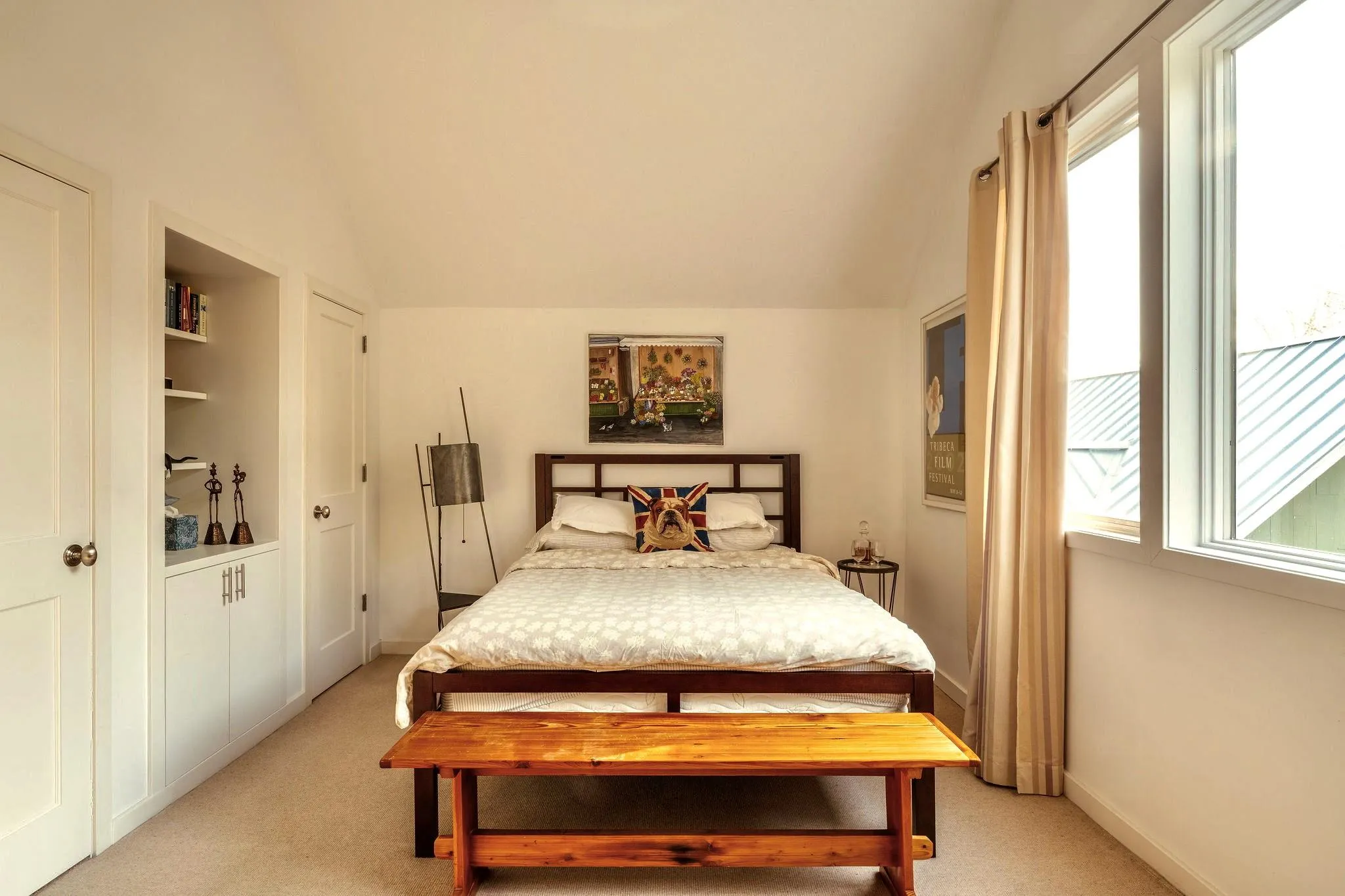 Bedroom with light carpet, vaulted ceiling, multiple windows, and baseboards Bedroom with light carpet, vaulted ceiling, multiple windows, and baseboards