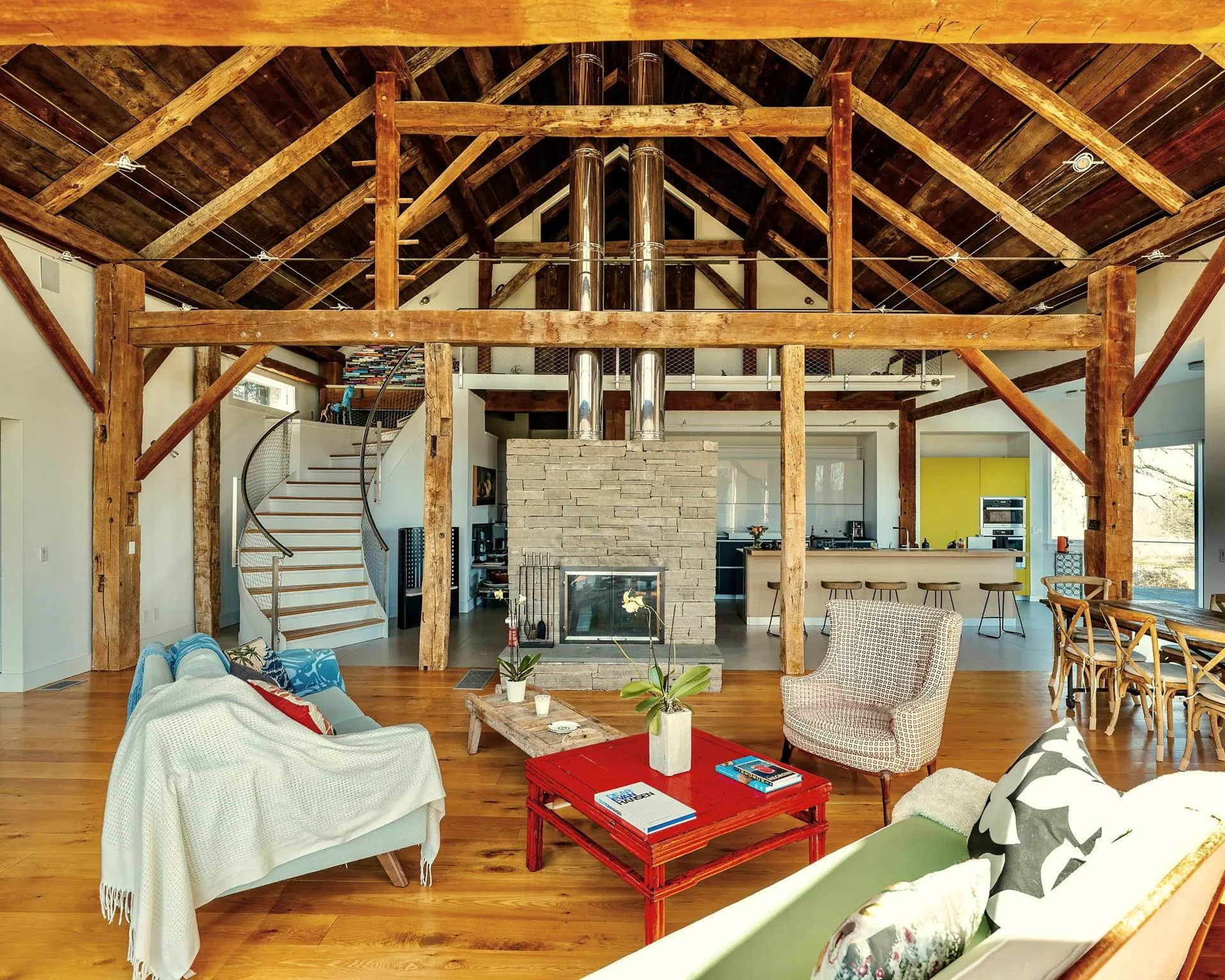 Living area with stairs, a fireplace, wooden ceiling, wood finished floors, and high vaulted ceiling Living area with stairs, a fireplace, wooden ceiling, wood finished floors, and high vaulted ceiling