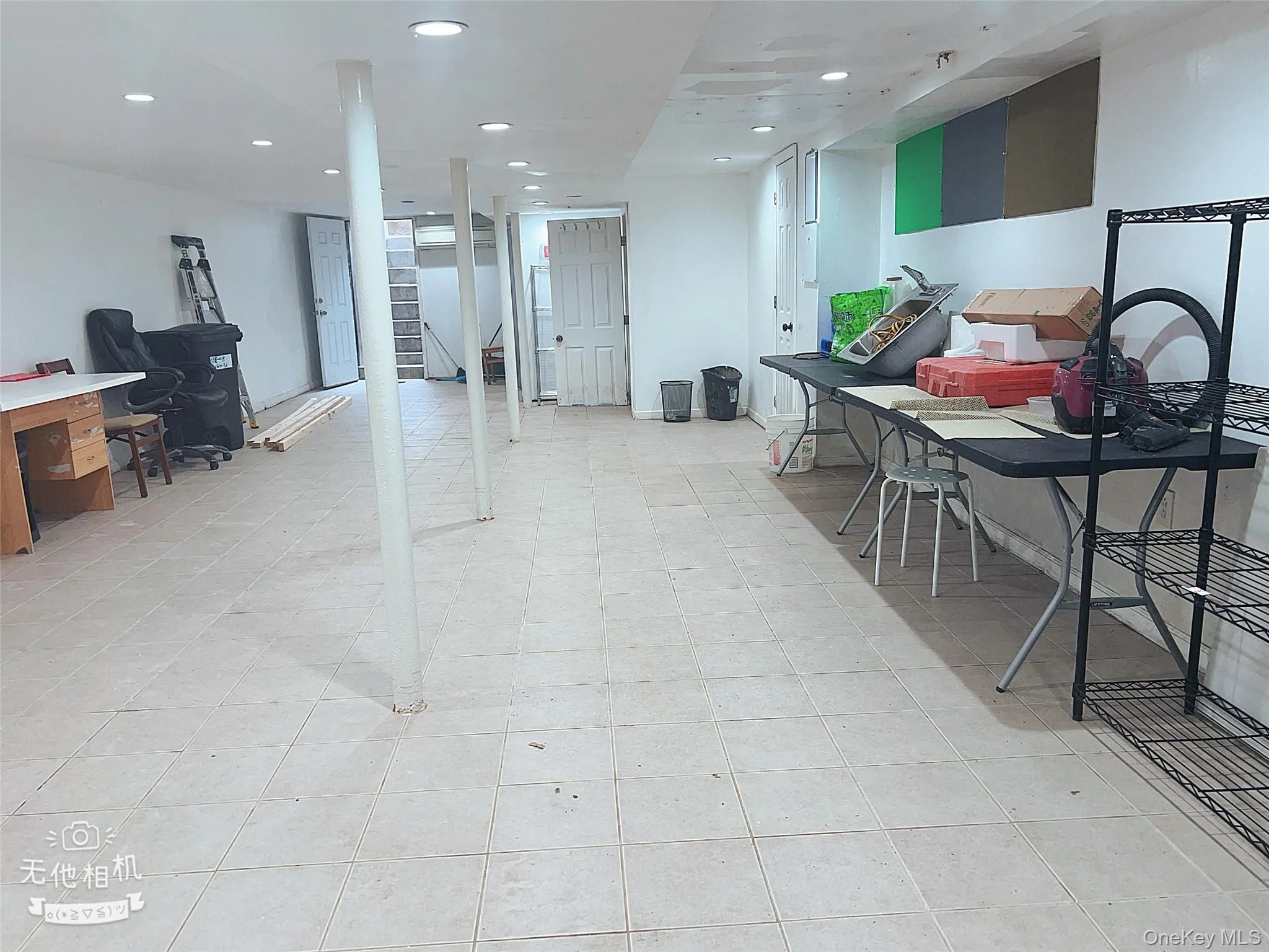 Below grade area with recessed lighting and light tile patterned floors Below grade area with recessed lighting and light tile patterned floors