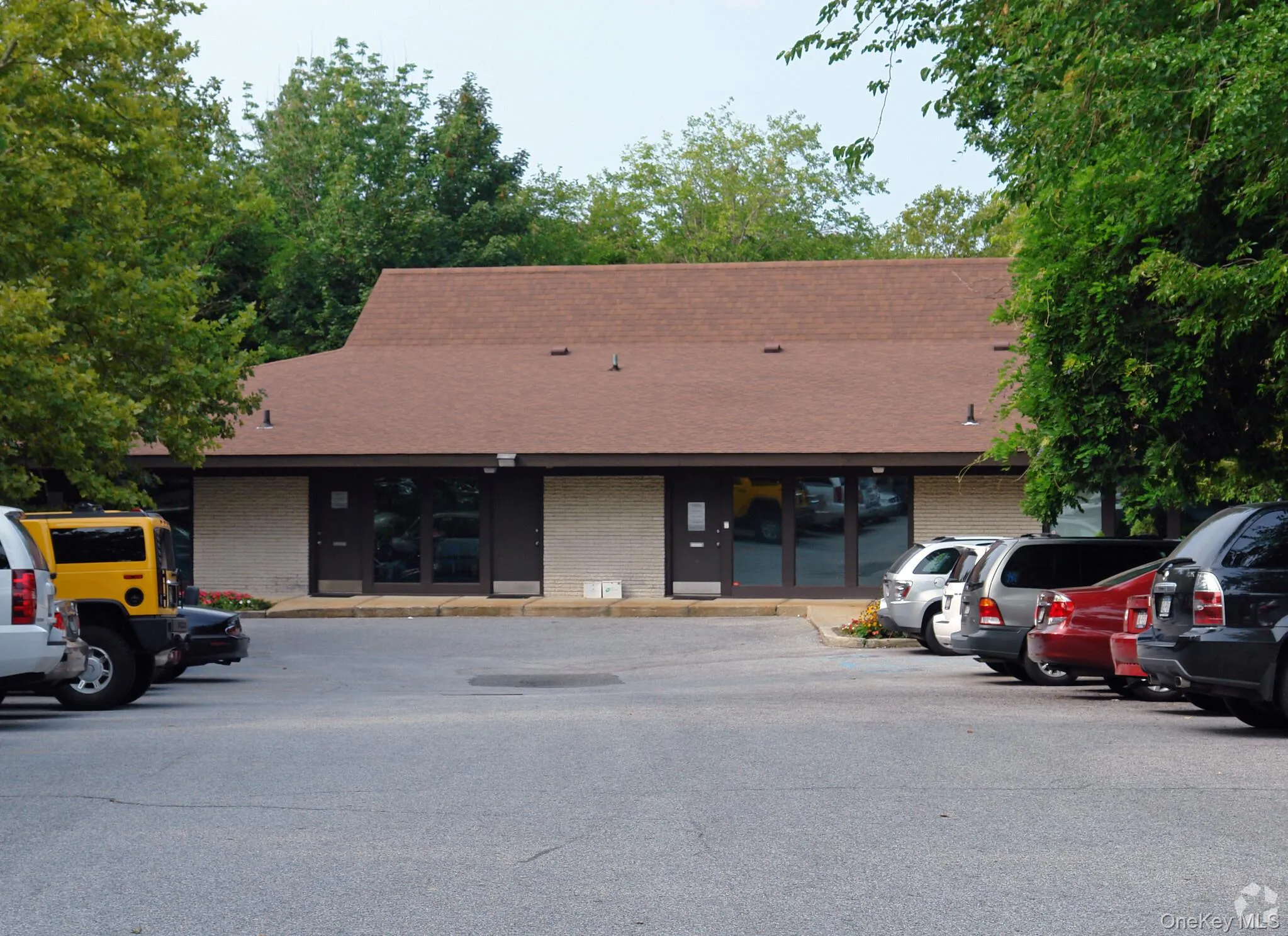 View of building exterior with uncovered parking View of building exterior with uncovered parking