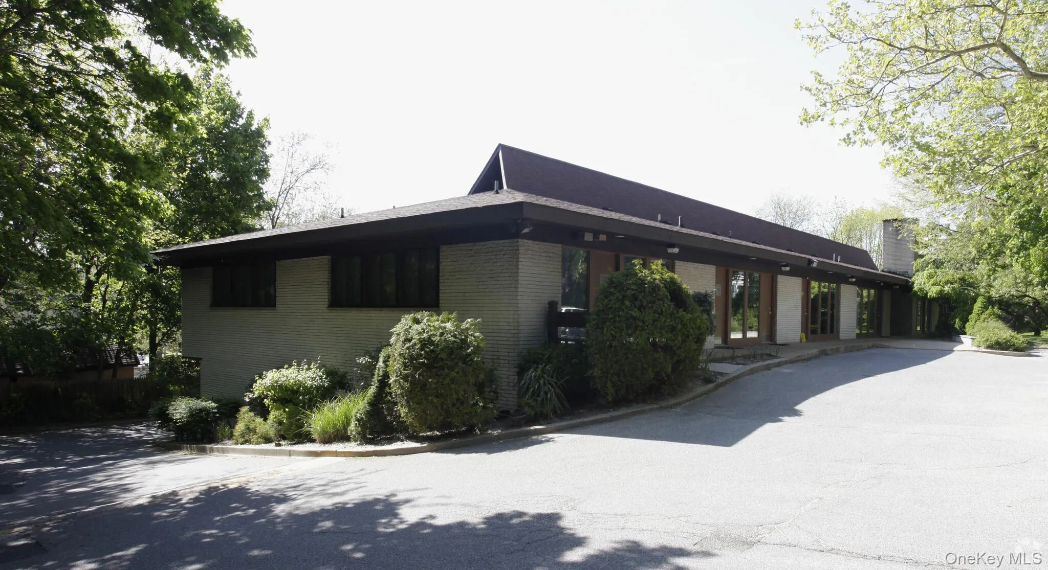 View of home's exterior with a chimney and brick siding View of home's exterior with a chimney and brick siding
