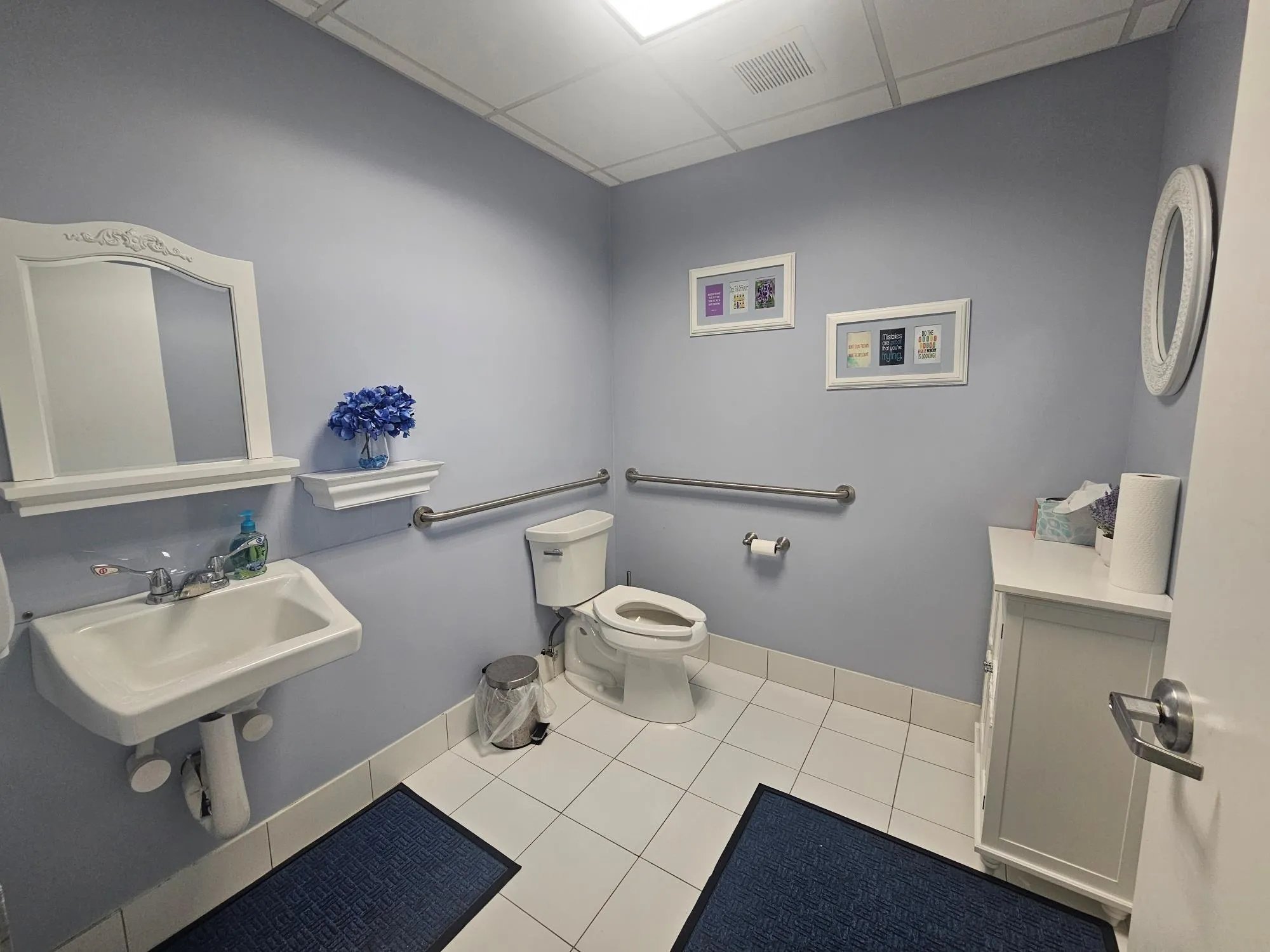 Half bath with a drop ceiling, toilet, tile patterned flooring, and baseboards Half bath with a drop ceiling, toilet, tile patterned flooring, and baseboards