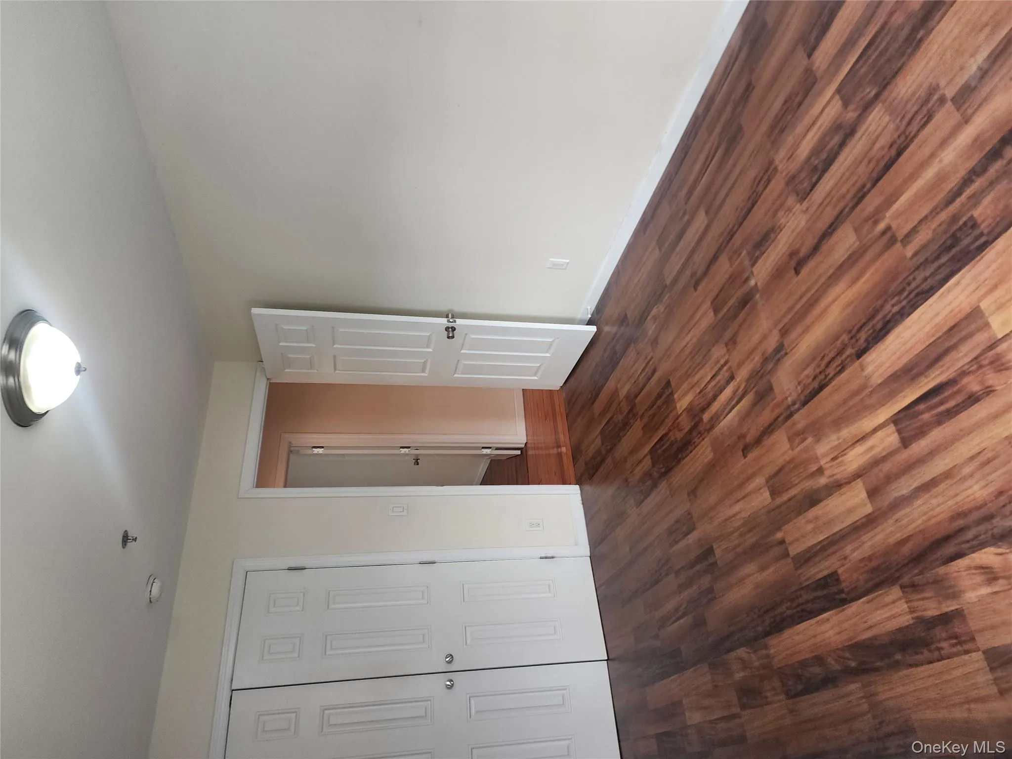 Unfurnished bedroom featuring dark wood-style floors and a closet Unfurnished bedroom featuring dark wood-style floors and a closet