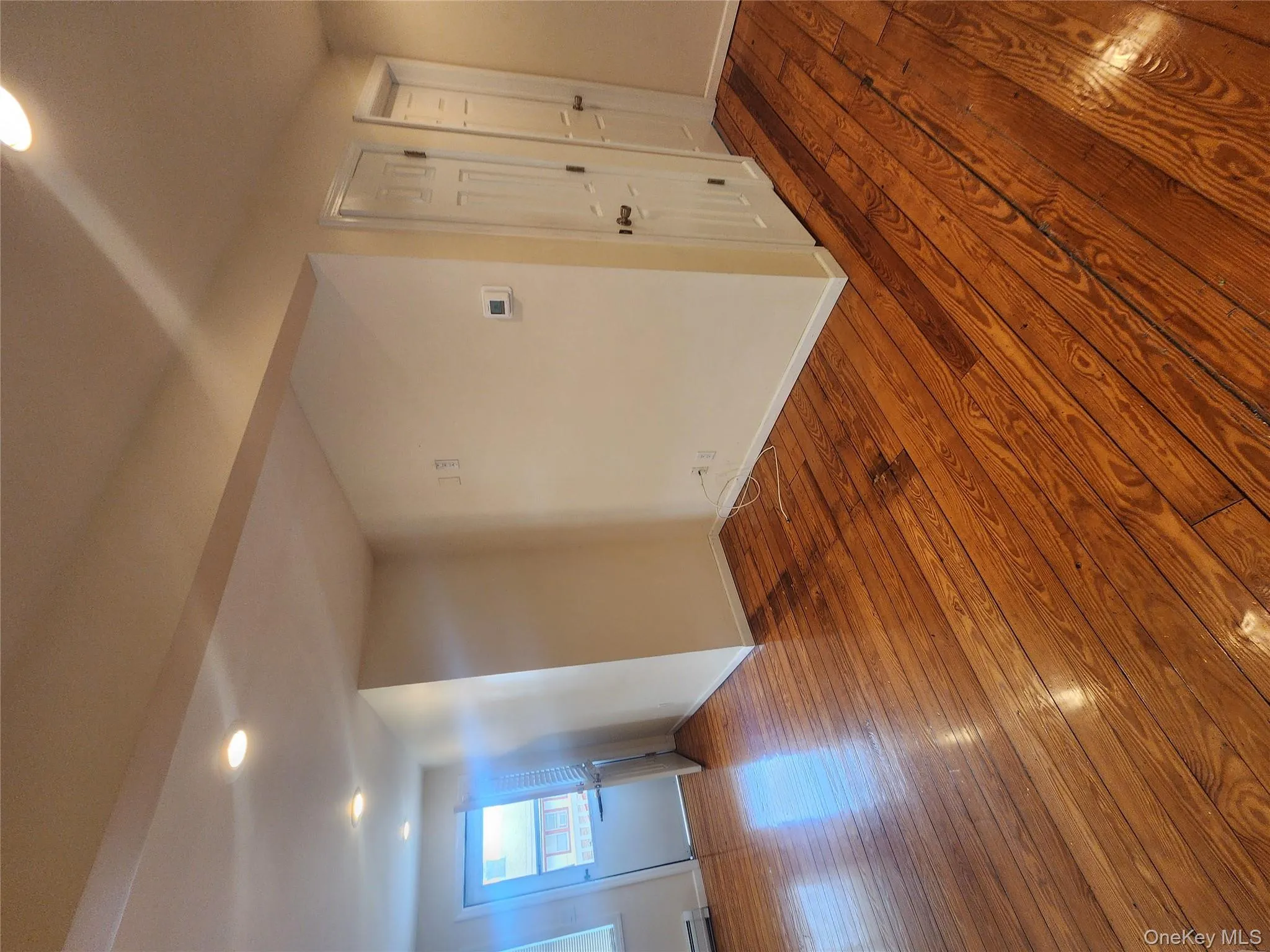 Spare room with wood-type flooring and recessed lighting Spare room with wood-type flooring and recessed lighting