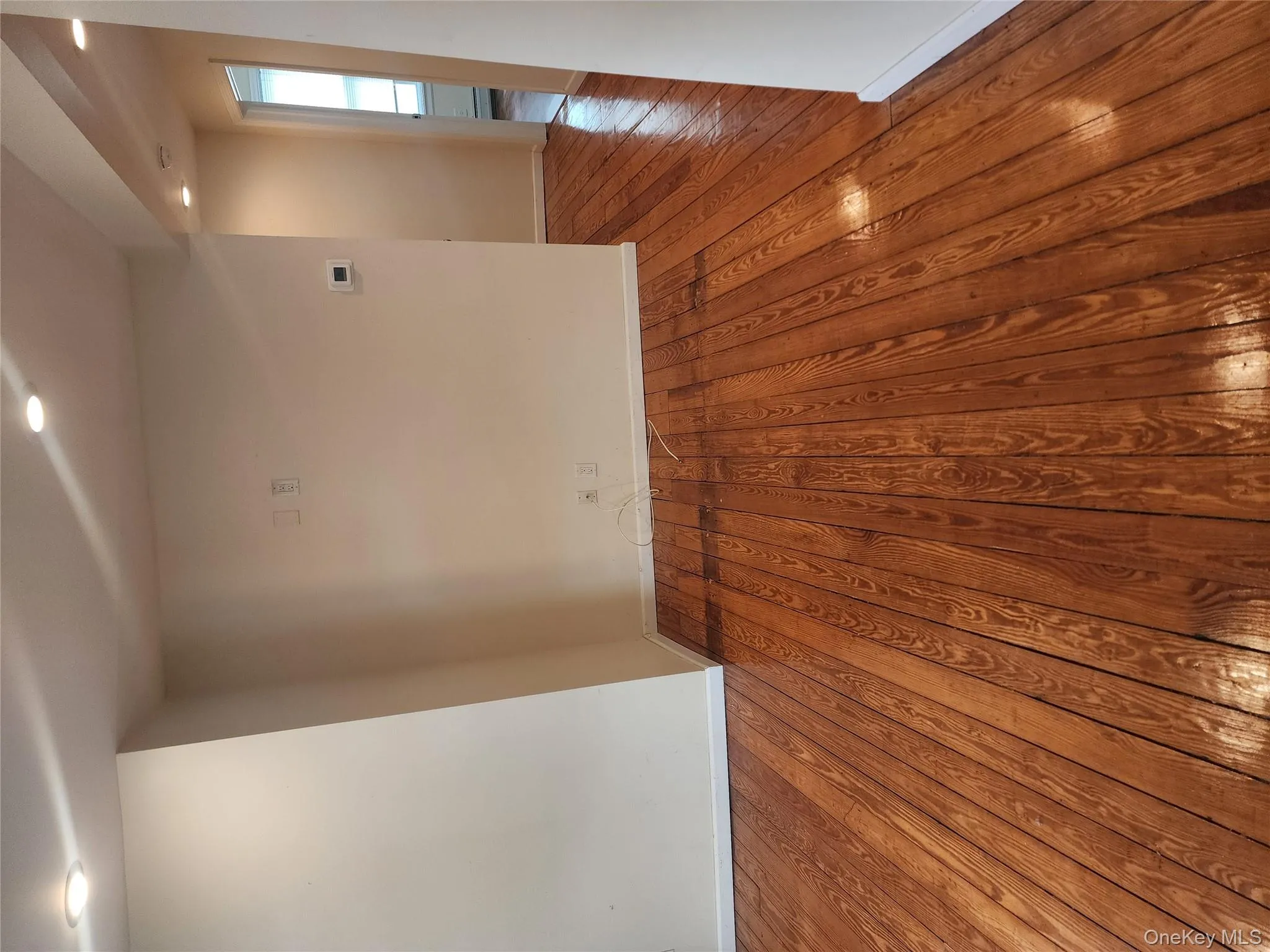 Spare room with wood finished floors and recessed lighting Spare room with wood finished floors and recessed lighting