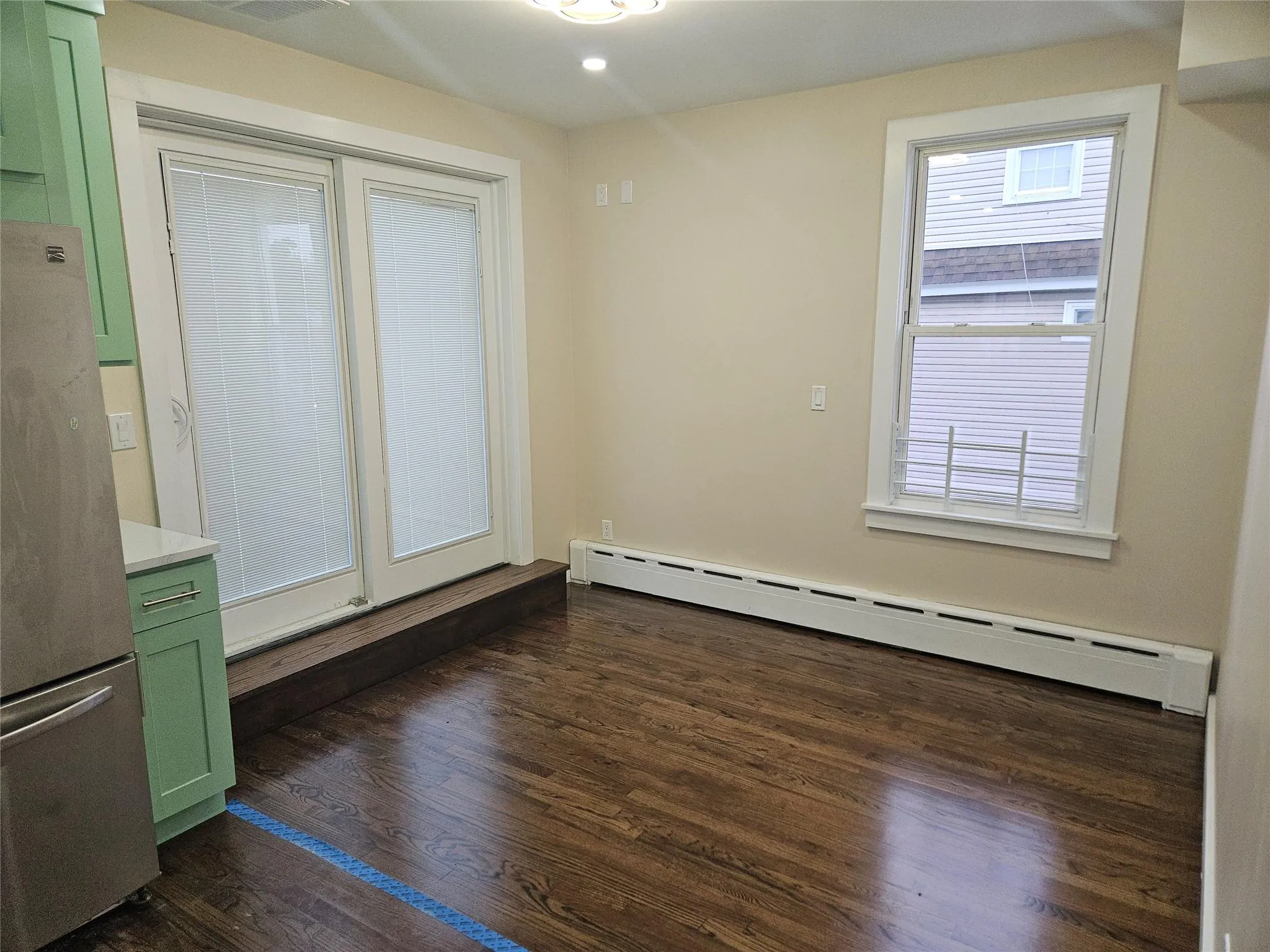 Unfurnished room featuring baseboard heating, dark wood finished floors, and recessed lighting Unfurnished room featuring baseboard heating, dark wood finished floors, and recessed lighting
