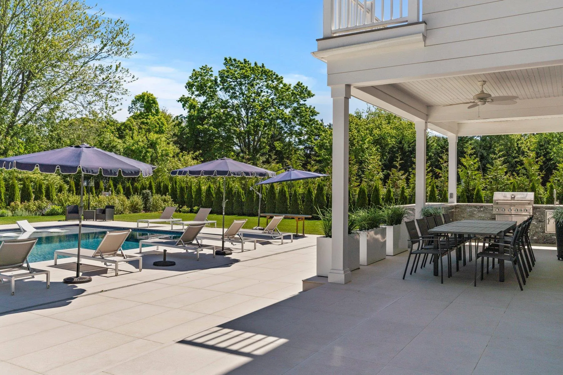 View of patio / terrace featuring outdoor dining space, an outdoor pool, ceiling fan, and a balcony View of patio / terrace featuring outdoor dining space, an outdoor pool, ceiling fan, and a balcony