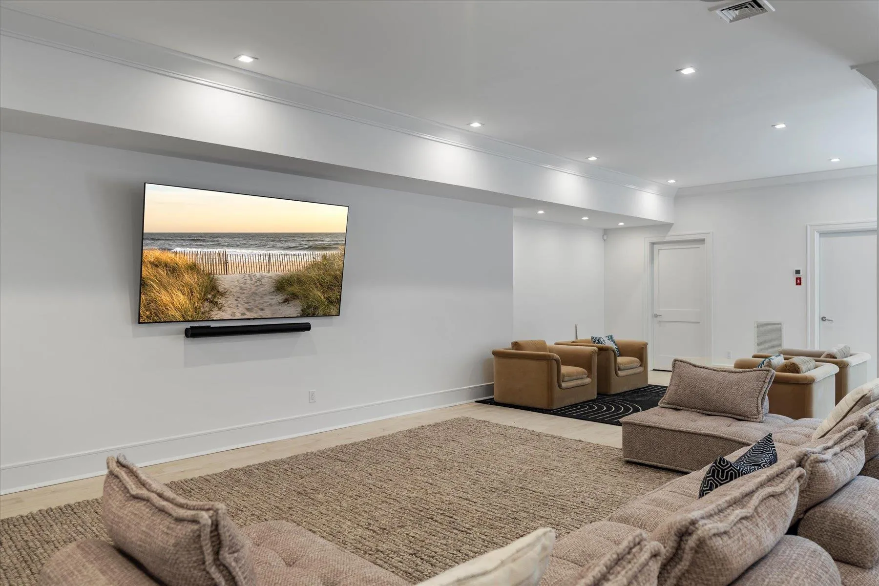 Living area featuring crown molding, wood finished floors, recessed lighting, and baseboards Living area featuring crown molding, wood finished floors, recessed lighting, and baseboards