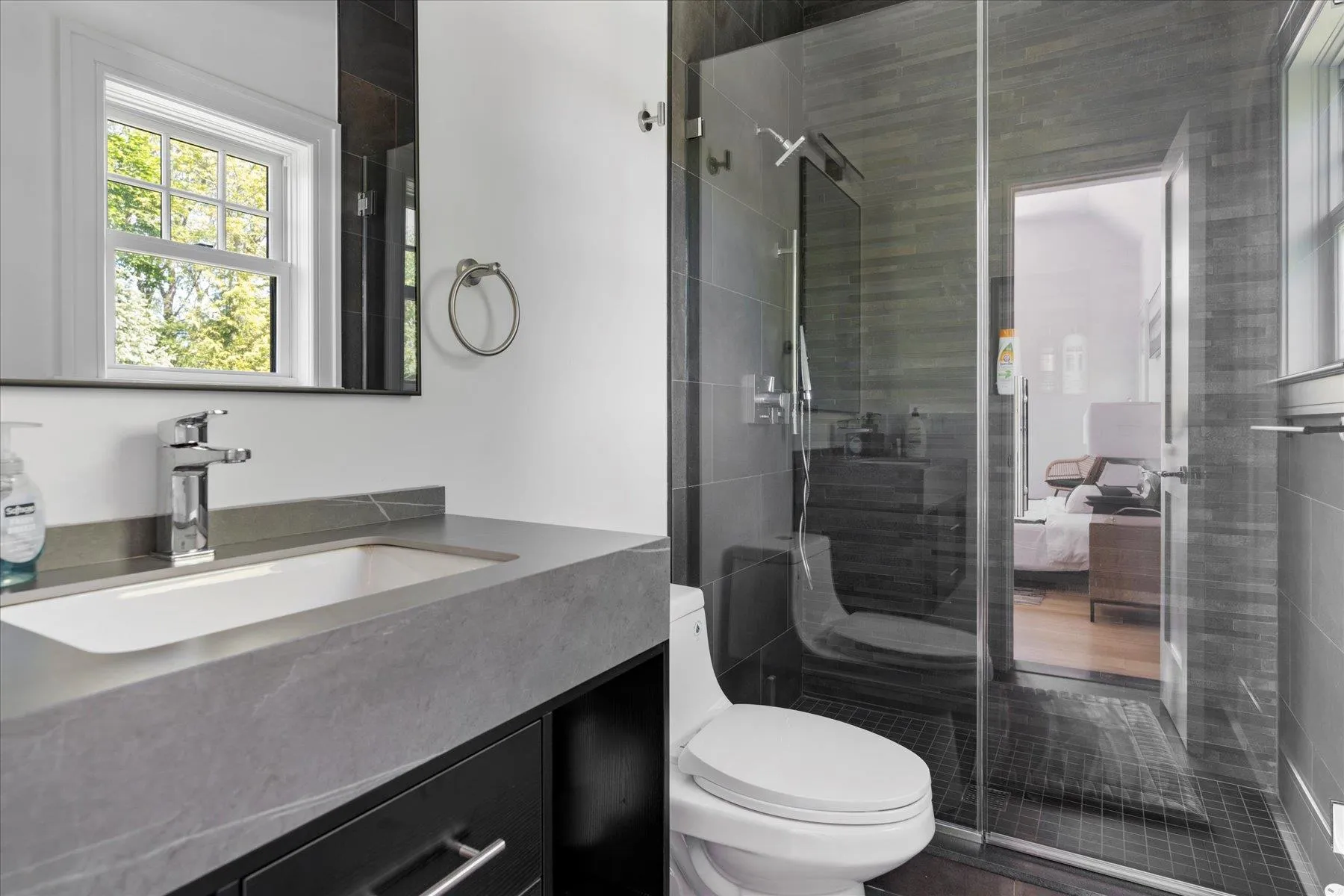 Bathroom with toilet, vanity, and a stall shower Bathroom with toilet, vanity, and a stall shower