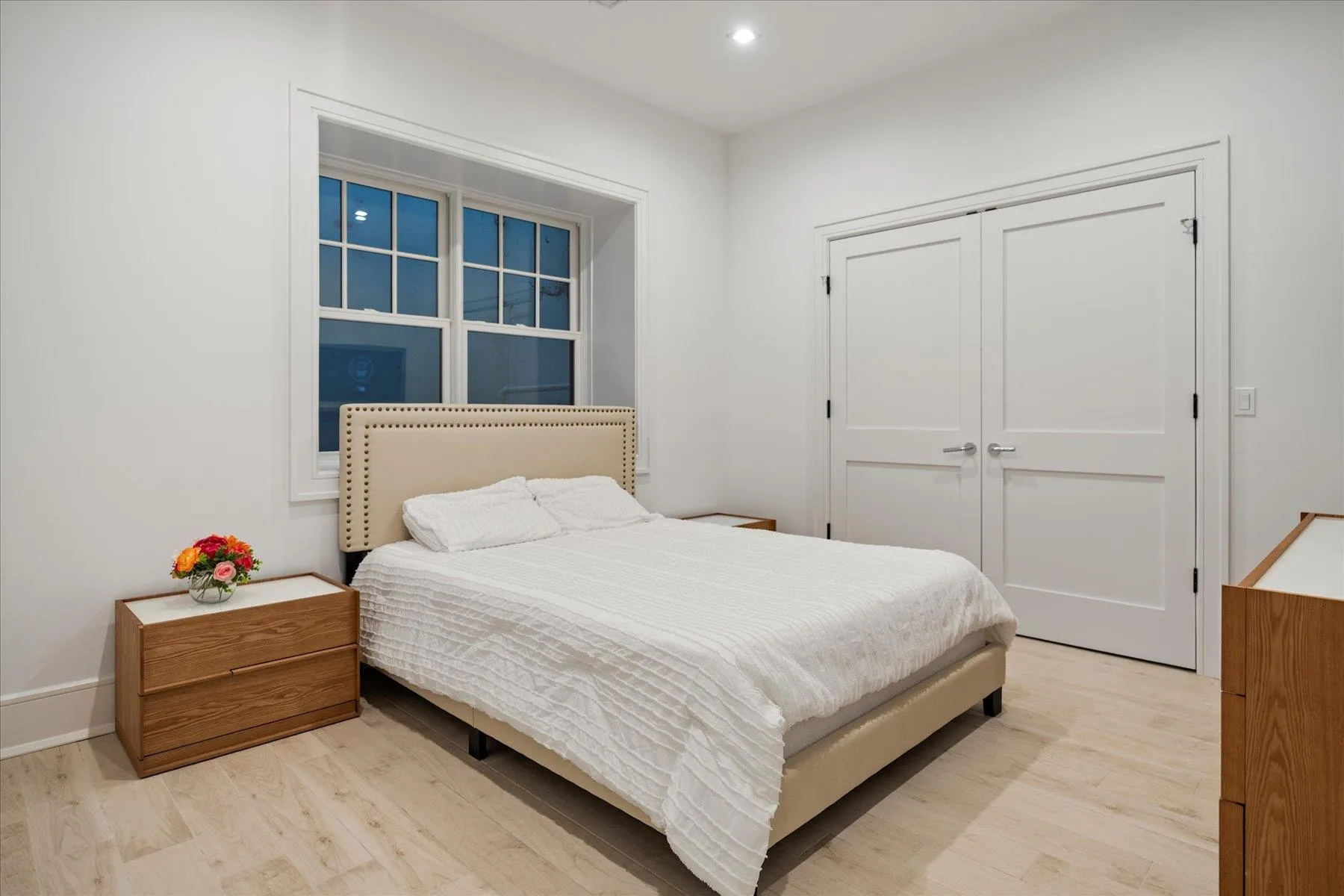 Bedroom featuring light wood-type flooring, recessed lighting, and a closet Bedroom featuring light wood-type flooring, recessed lighting, and a closet