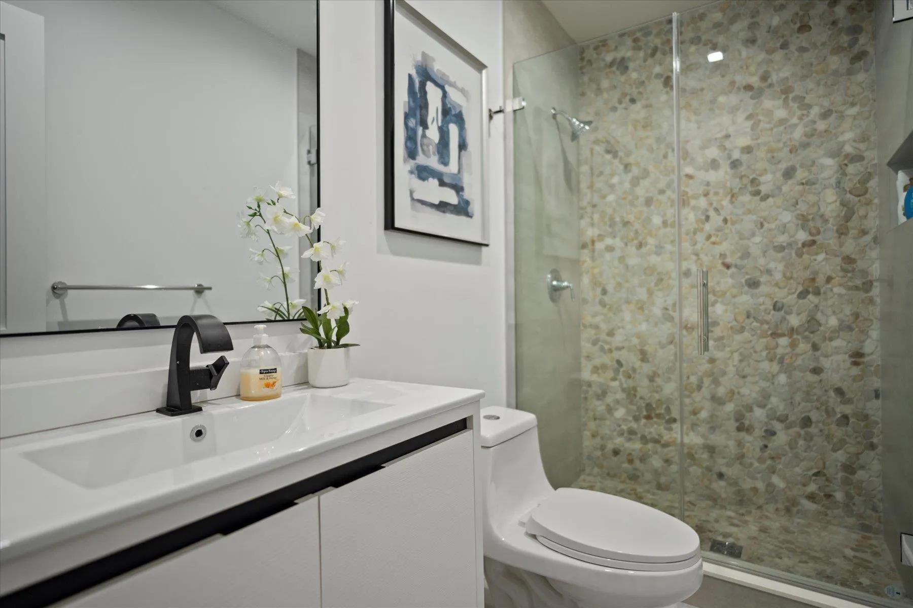 Full bath featuring vanity, a stall shower, and toilet Full bath featuring vanity, a stall shower, and toilet