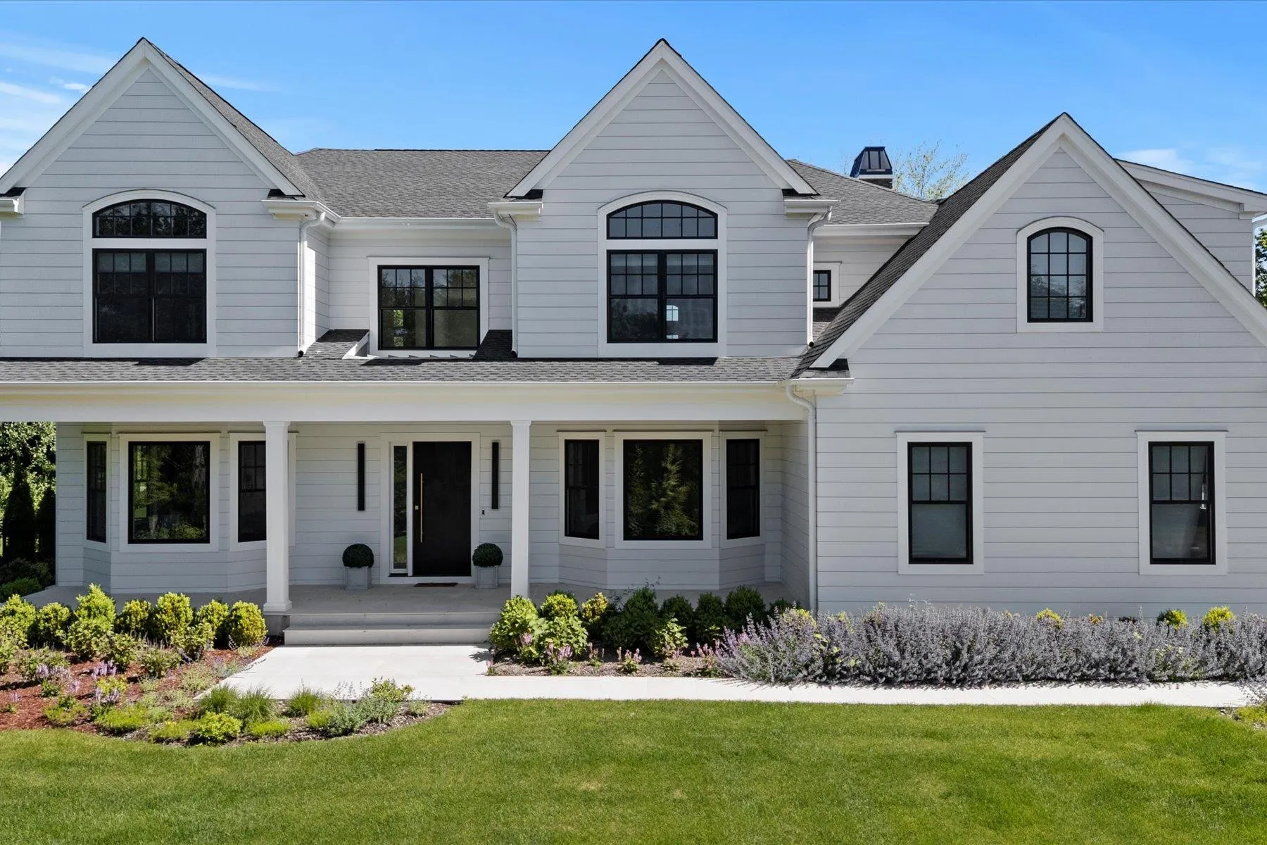 View of front of property featuring a porch, a front lawn, and roof with shingles View of front of property featuring a porch, a front lawn, and roof with shingles