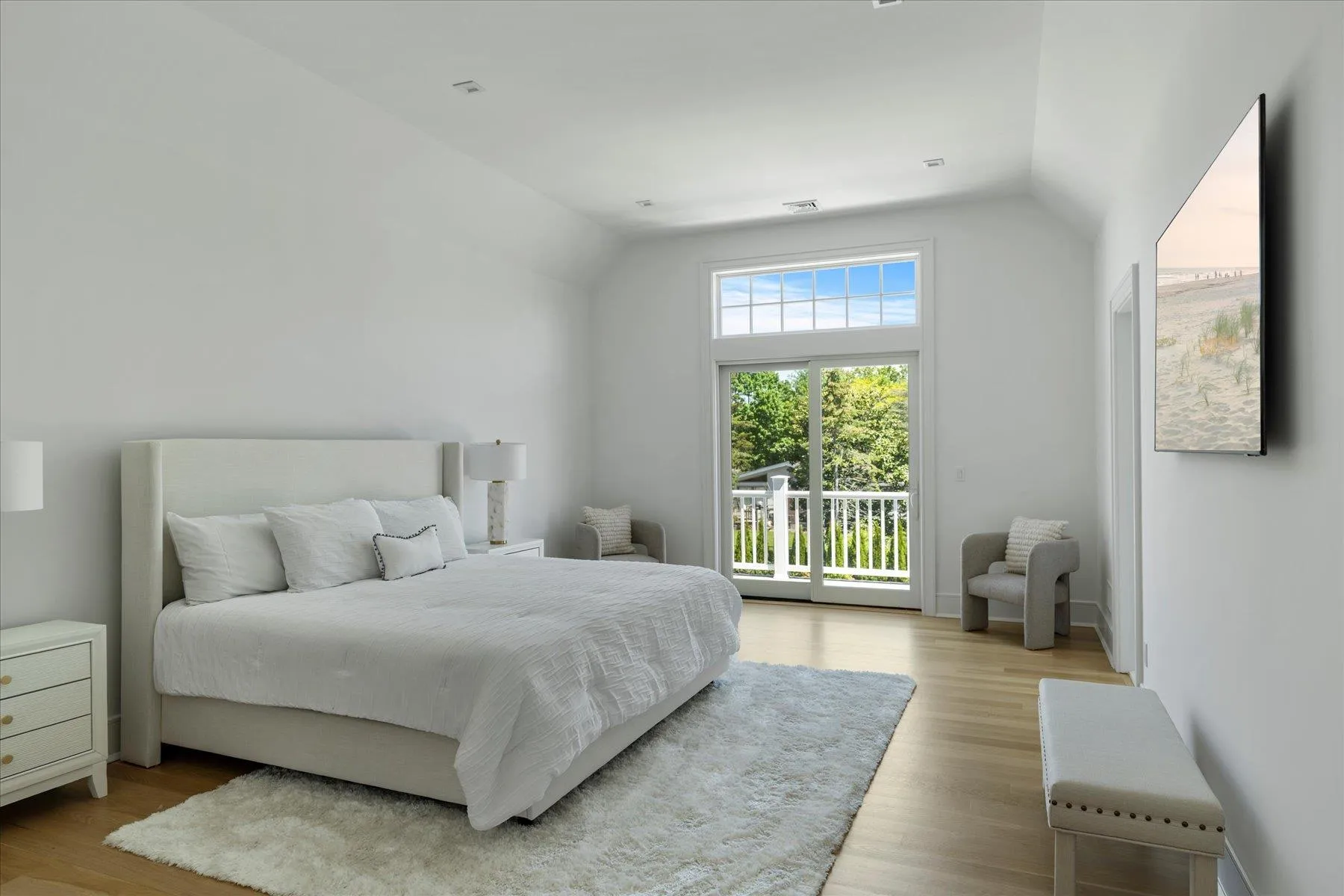 Bedroom with access to exterior, vaulted ceiling, and wood finished floors Bedroom with access to exterior, vaulted ceiling, and wood finished floors