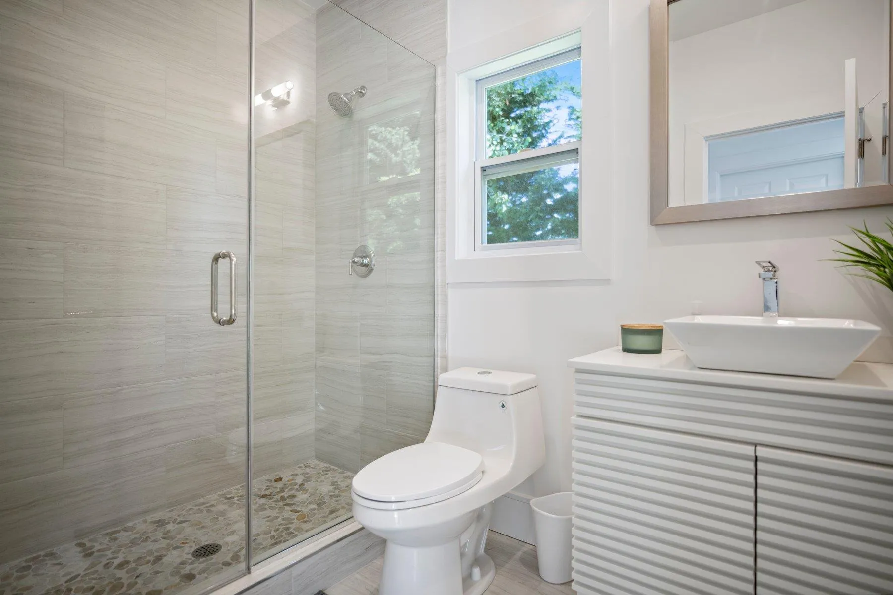 Bathroom featuring a stall shower, toilet, and vanity Bathroom featuring a stall shower, toilet, and vanity