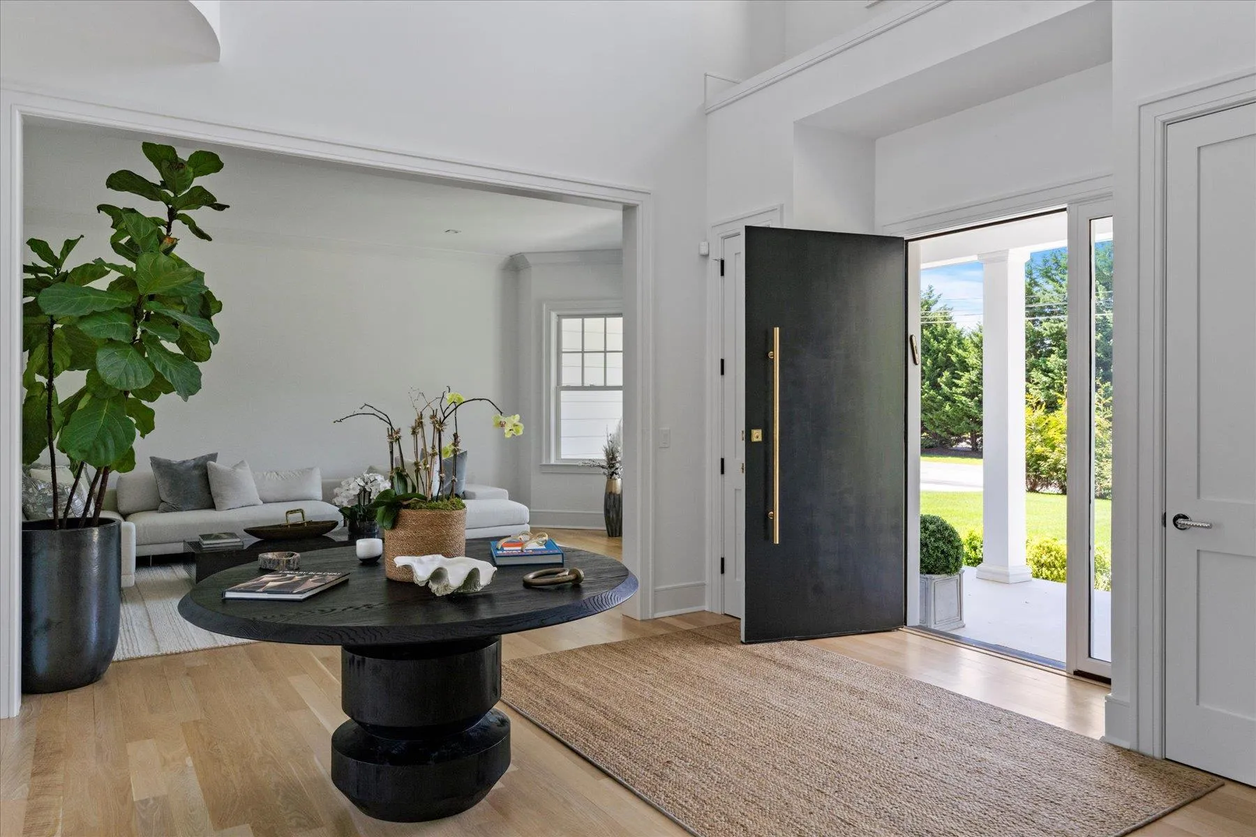 Entrance foyer featuring wood finished floors and a high ceiling Entrance foyer featuring wood finished floors and a high ceiling