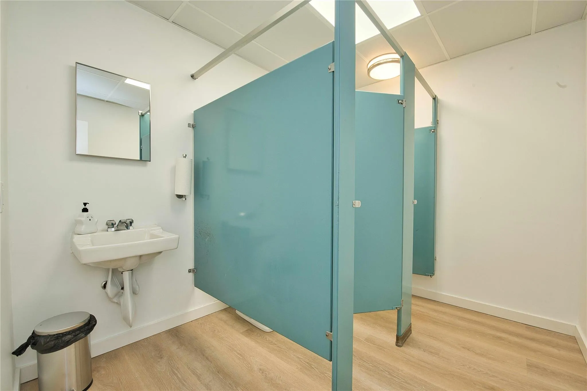 Bathroom with wood finished floors and baseboards Bathroom with wood finished floors and baseboards