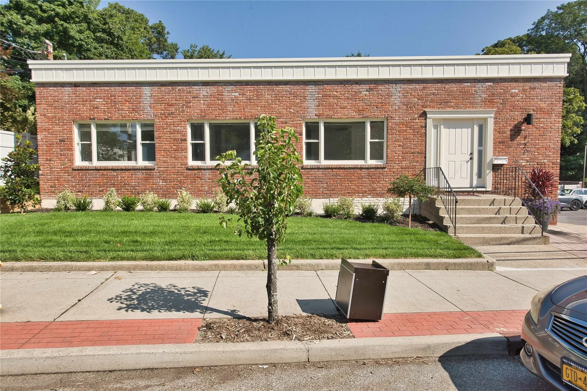 View of front of home with brick siding and a front lawn View of front of home with brick siding and a front lawn