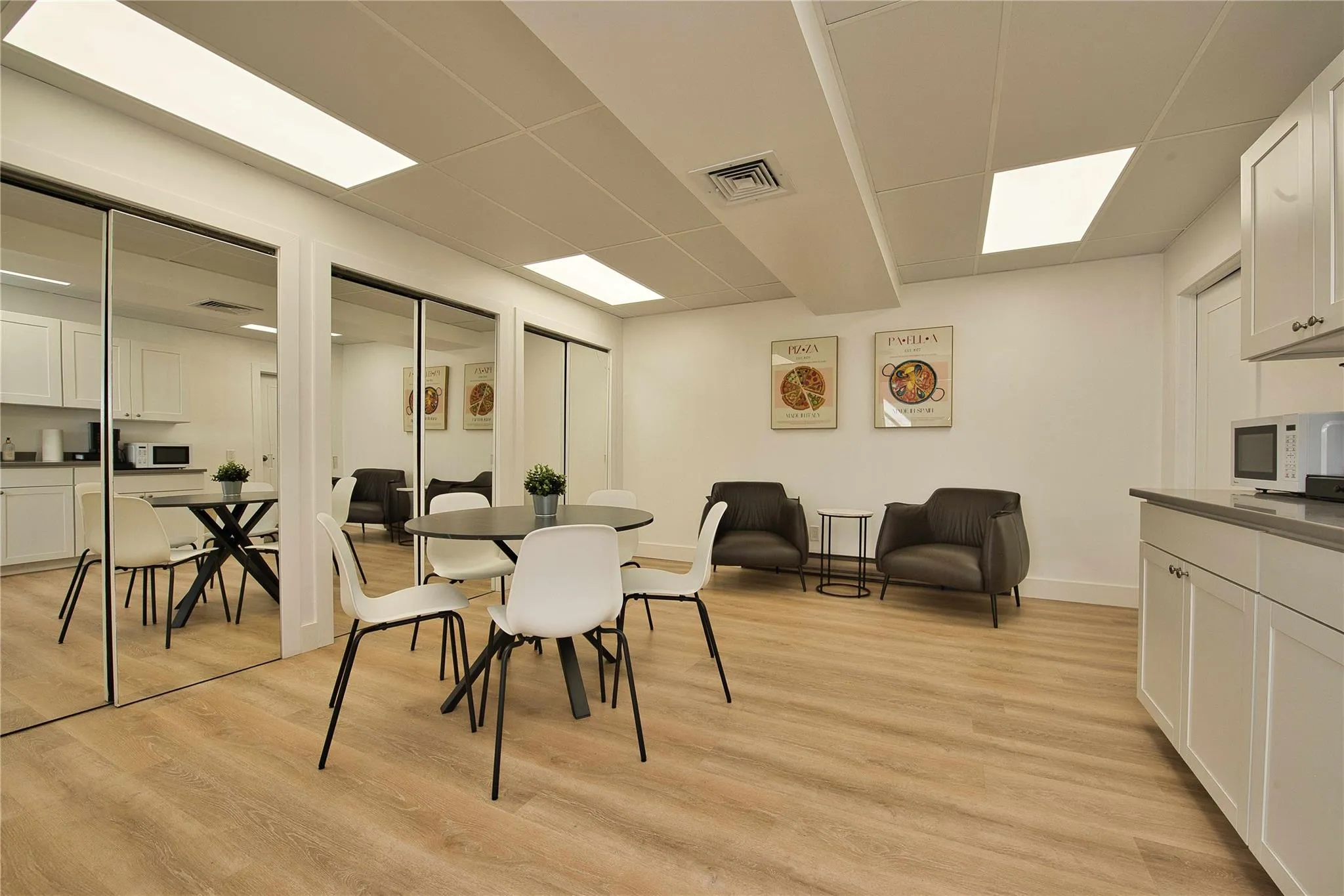 Dining area with light wood-style flooring, baseboards, and a paneled ceiling Dining area with light wood-style flooring, baseboards, and a paneled ceiling